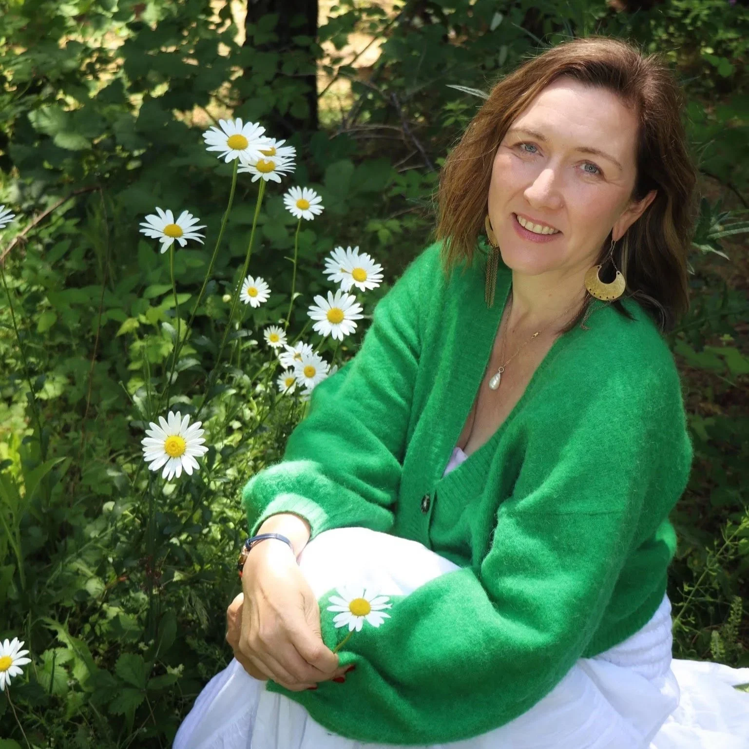 Kamila Loupalova, somatic mentor and depth work guide, in a warm portrait wearing