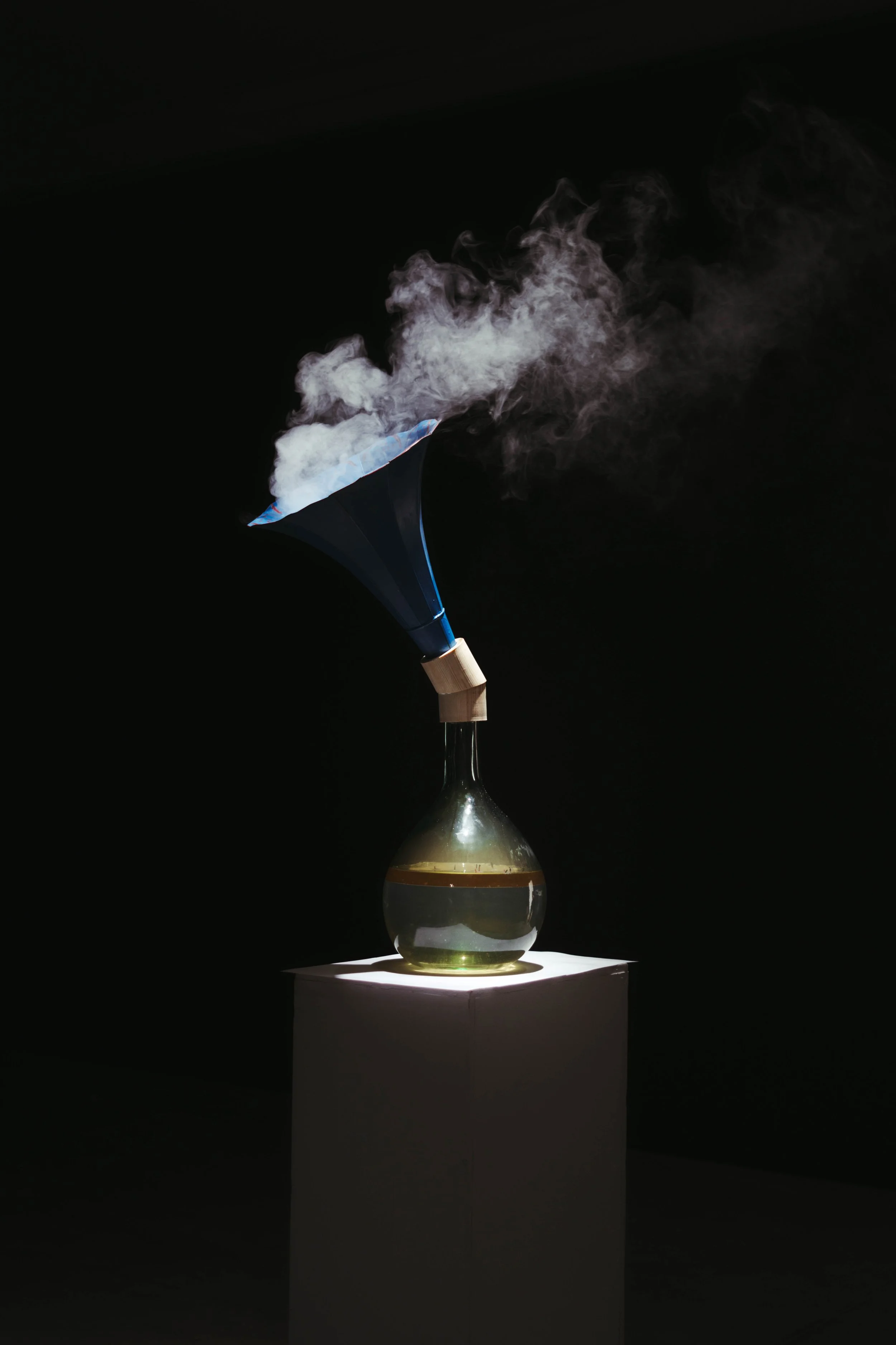 Olive Smoke, 2023
Glass bottle, water, olive oil, cotton, gramophone horn, smoke machine, variable dimensions