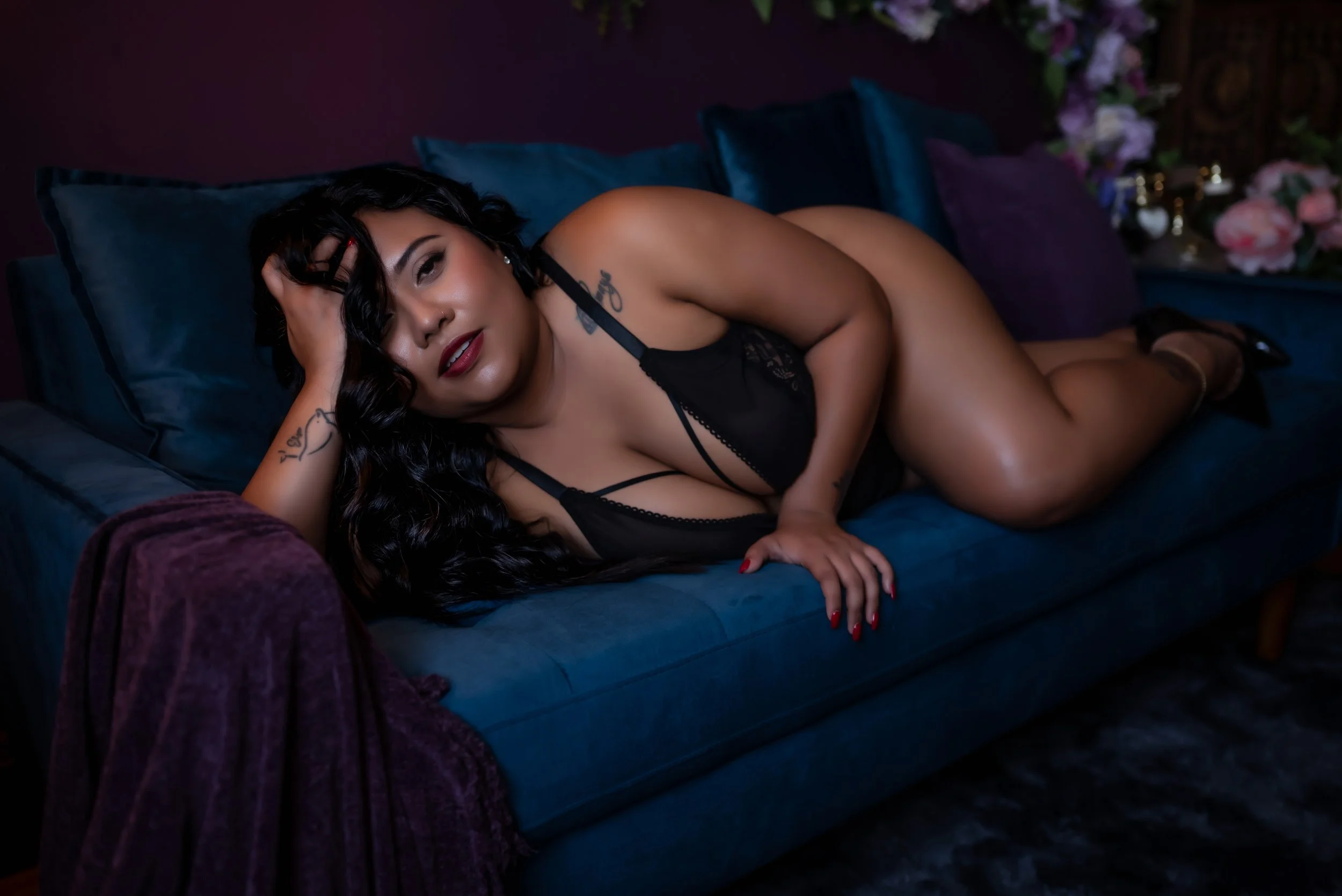 Woman from Belize laying on couch in Pittsburgh boudoir studio
