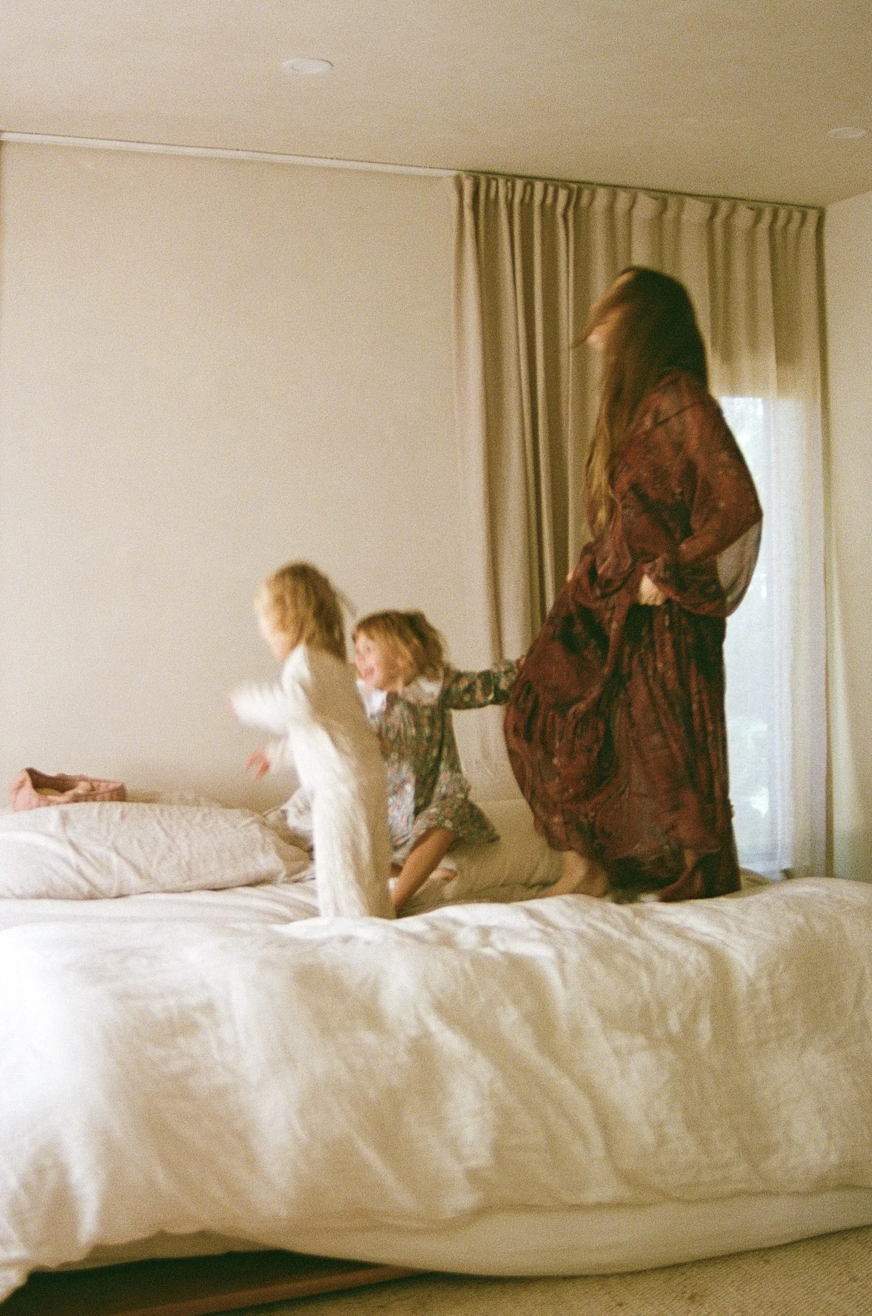 new mama with littles jumping on bed