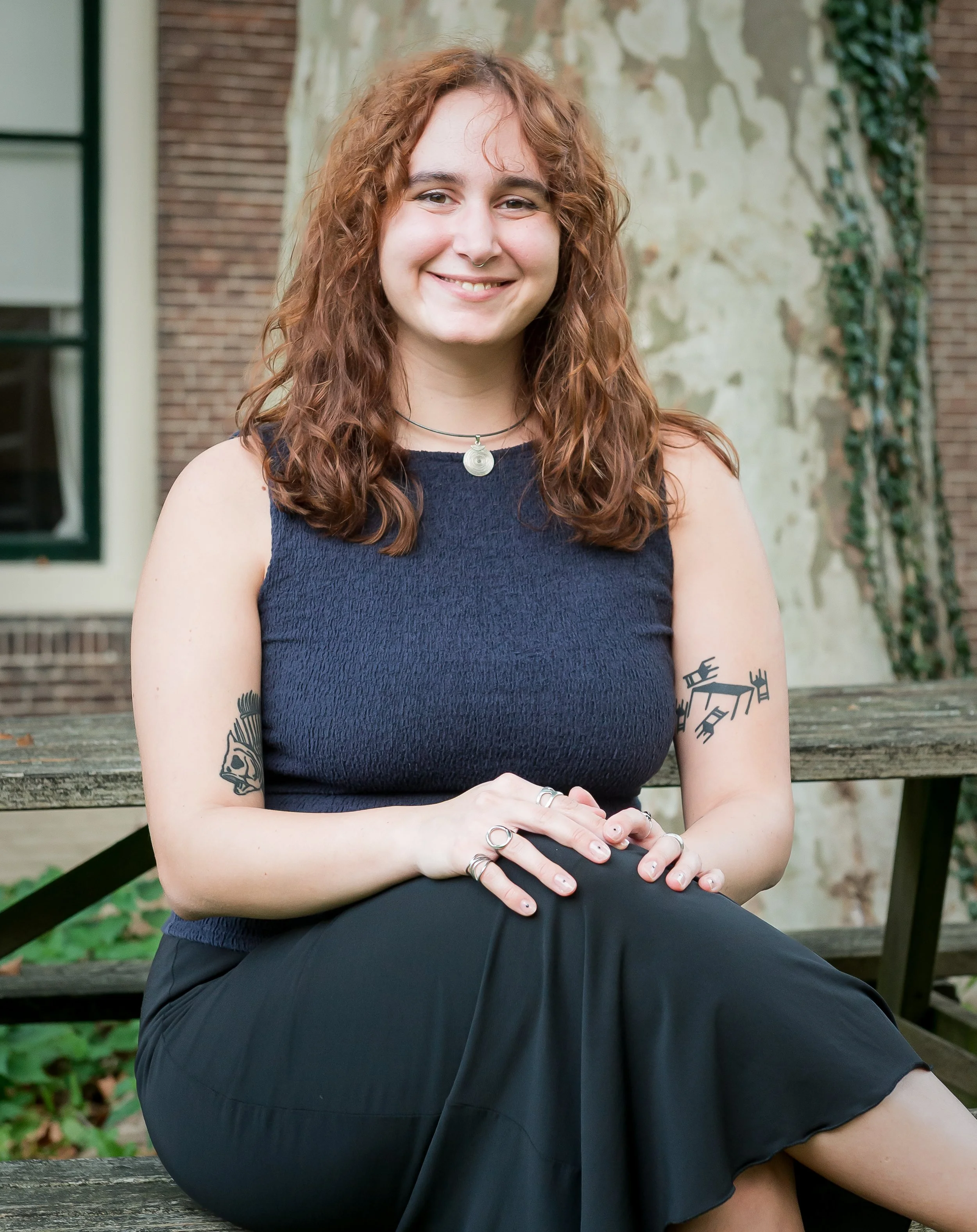 Woman sitting on wooden bench.