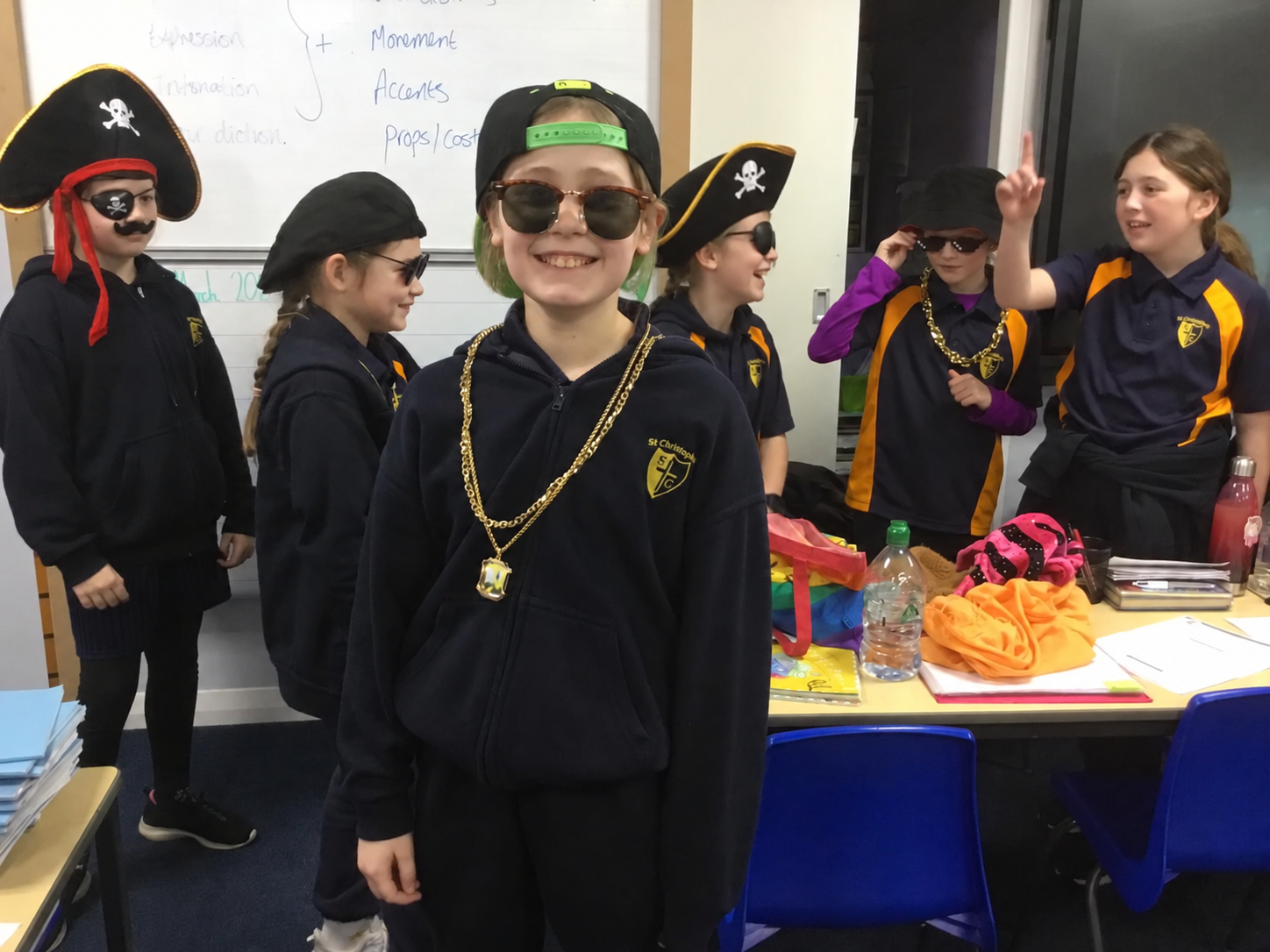Laughing pirate-hatted classmate in classroom.png