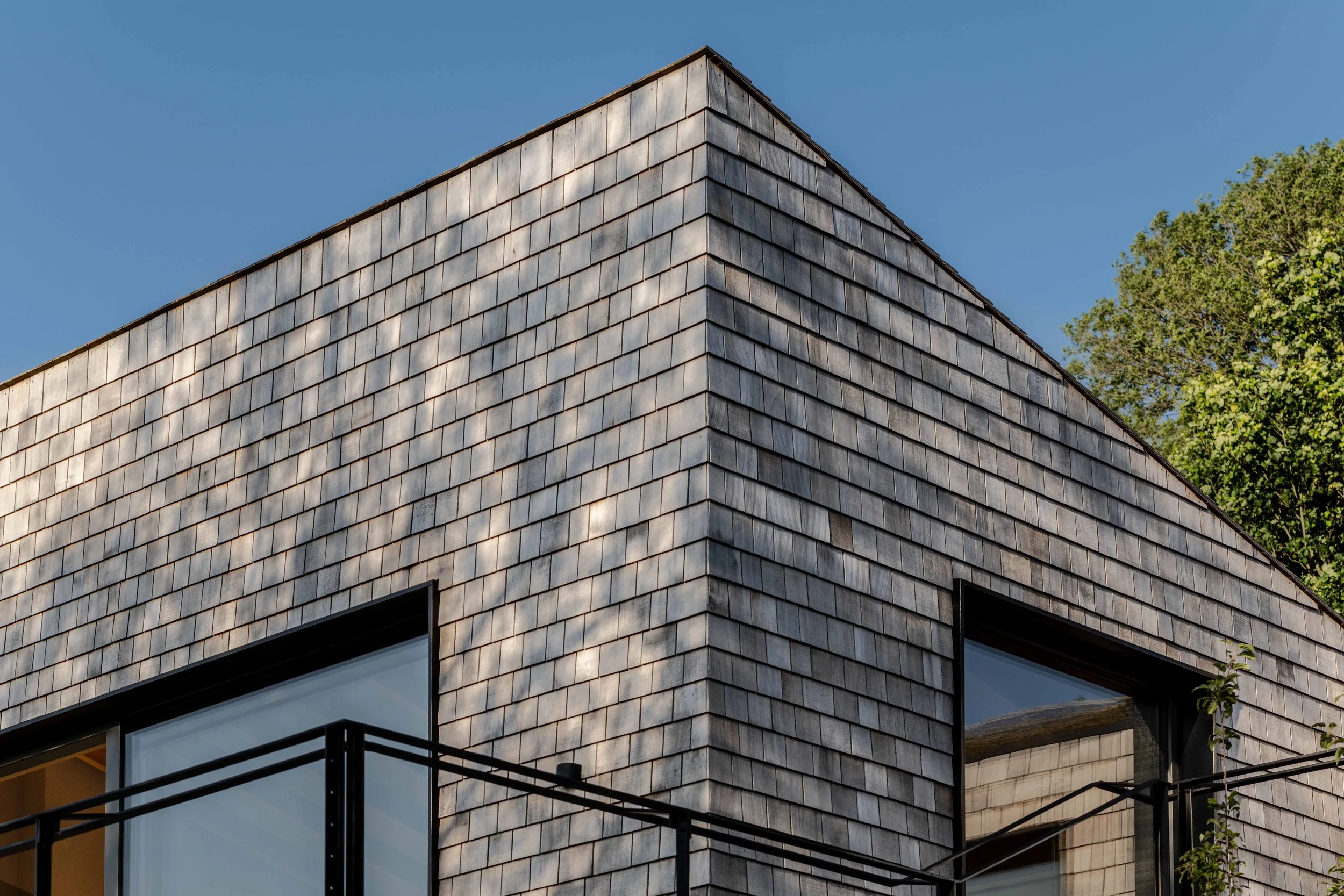 Forgeworks Architects — Modern building exterior with wood shingle cladding and large windows