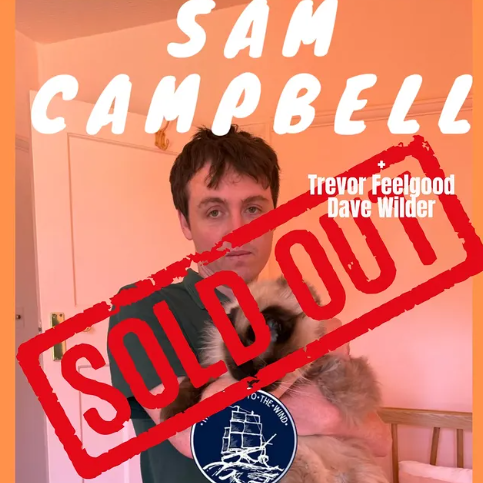 Image of a person holding a small dog in front of a warm-colored wall with text that reads "I AM CAMPBELL" and names "Trevor Feelgood" and "Dave Wilder." The image has a red "SOLD OUT" stamp across it.
