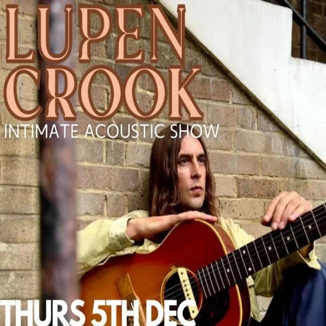 Poster for Lupen Crook's intimate acoustic show on Thursday, December 5th, featuring a man with long hair sitting outside against a brick wall, holding a guitar.