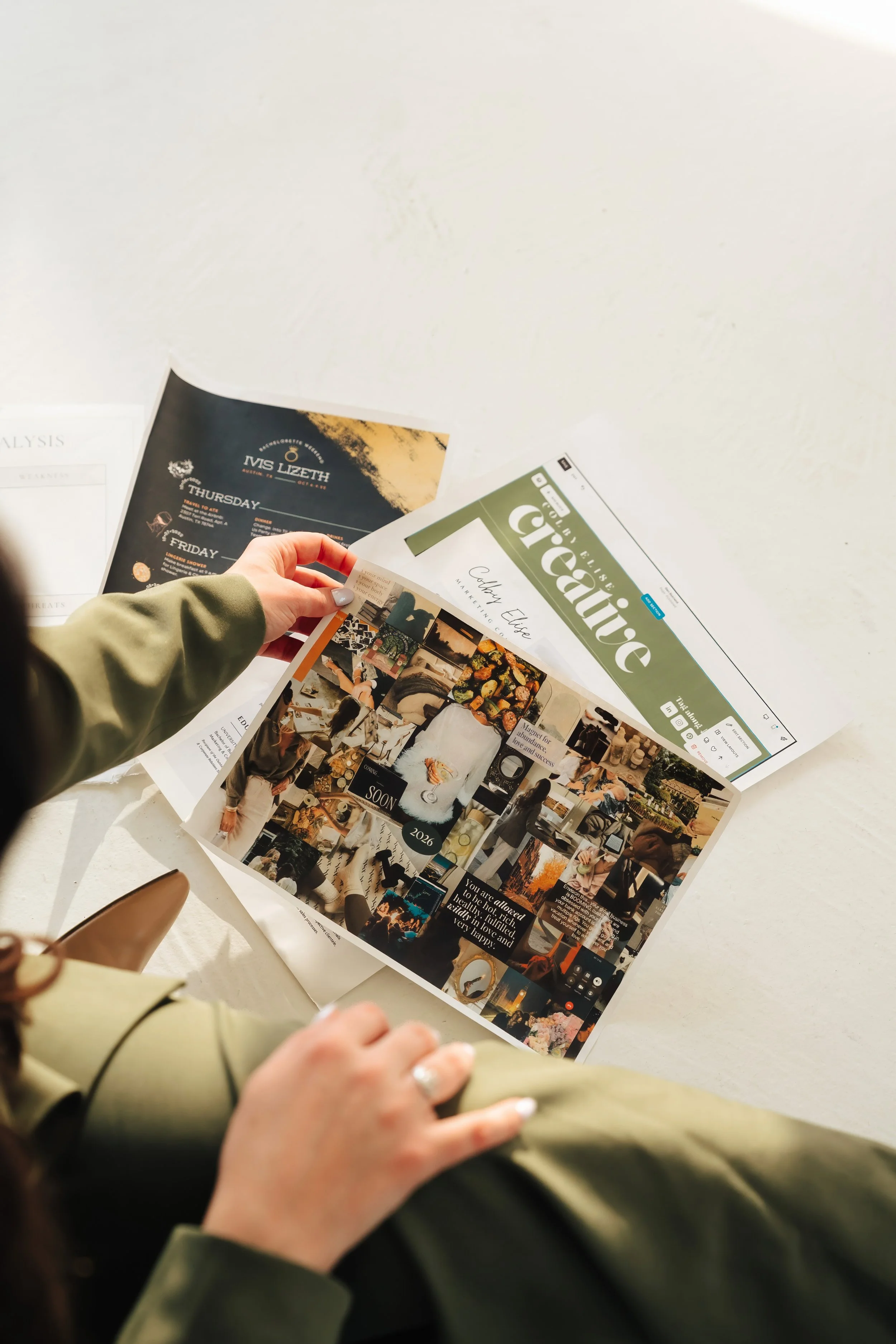 Woman holds up paper with colorful collage