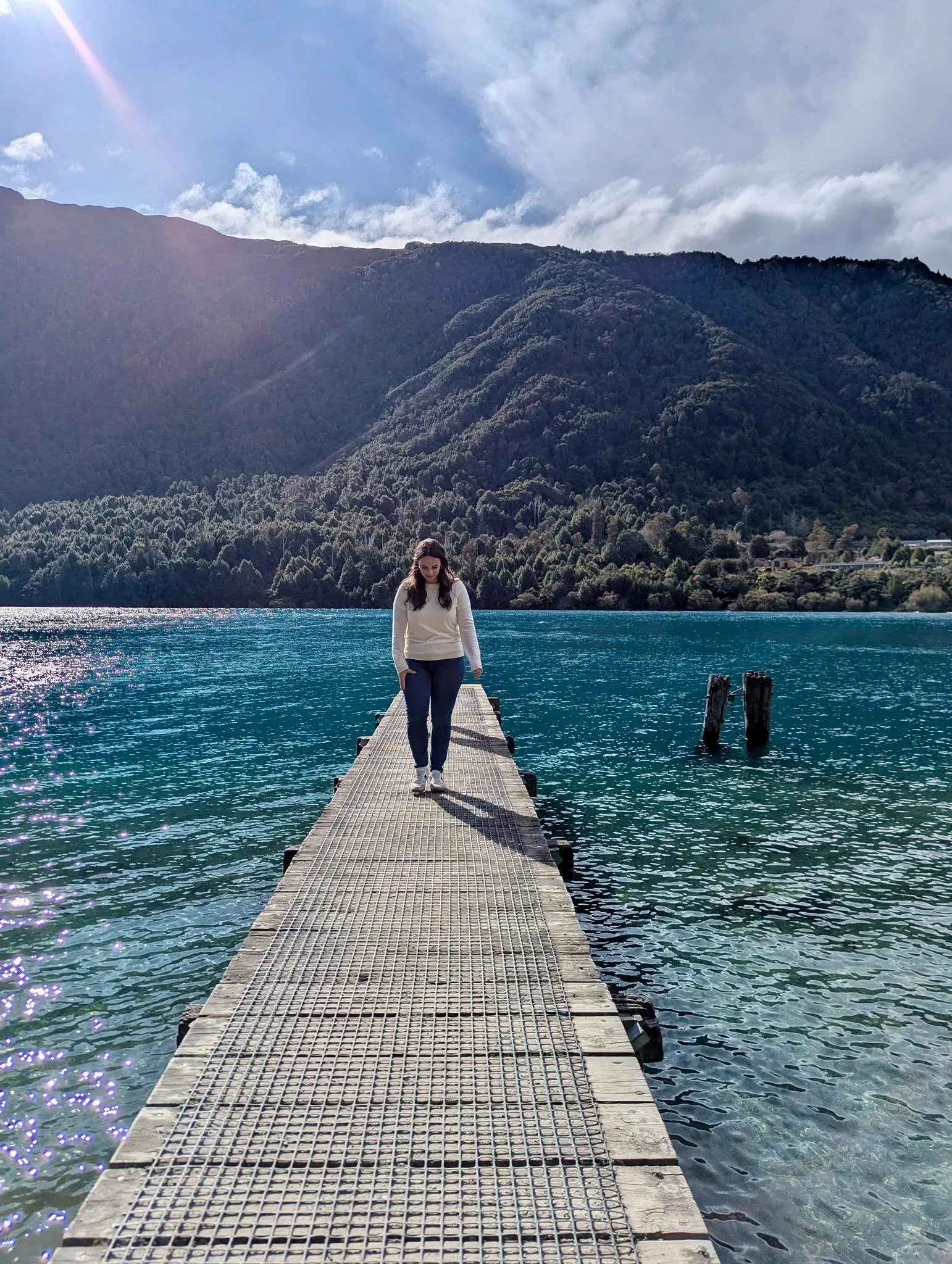 Woman walking on a pier on a lake in New Zealand