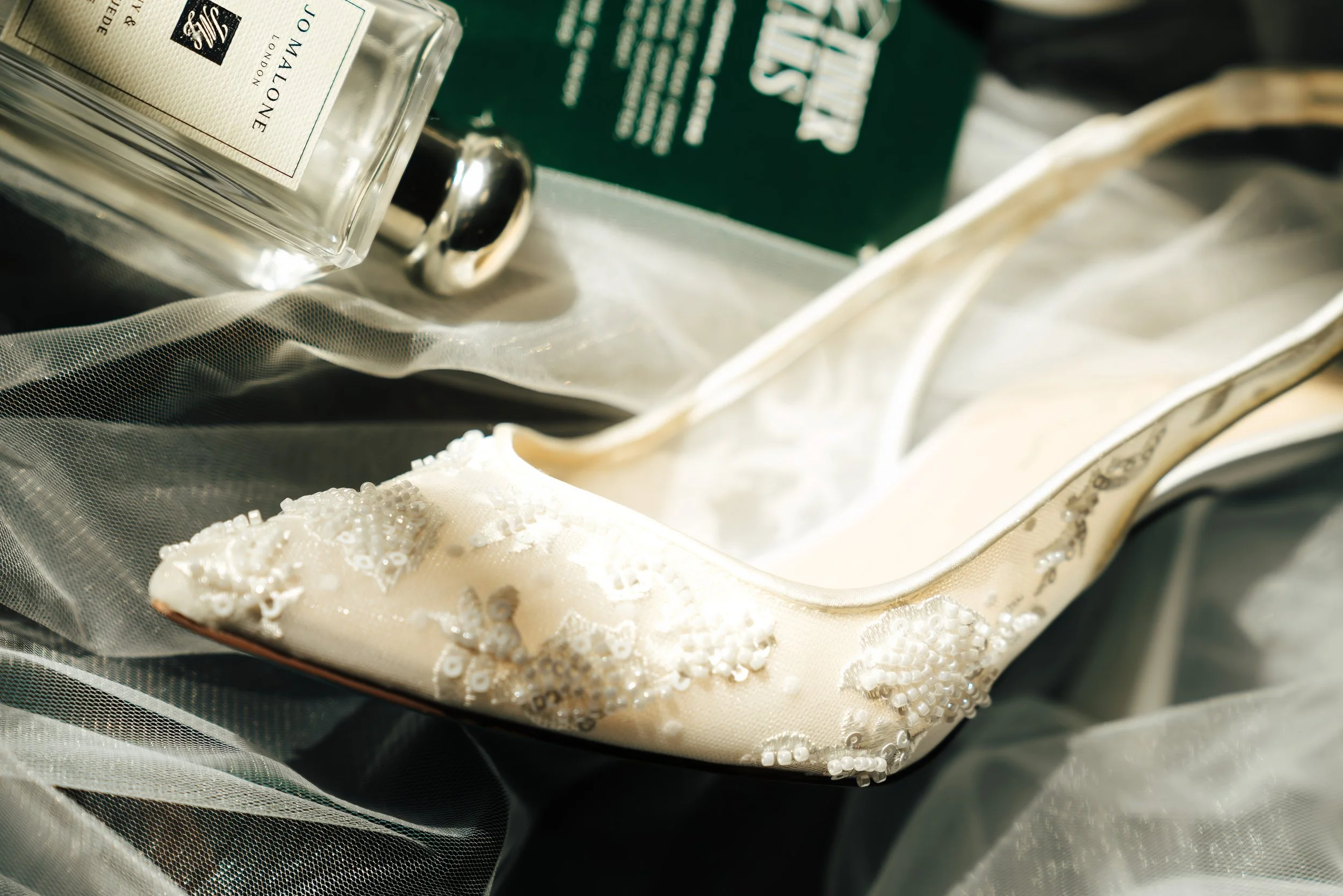 Detail shot of bridal shoes and perfume