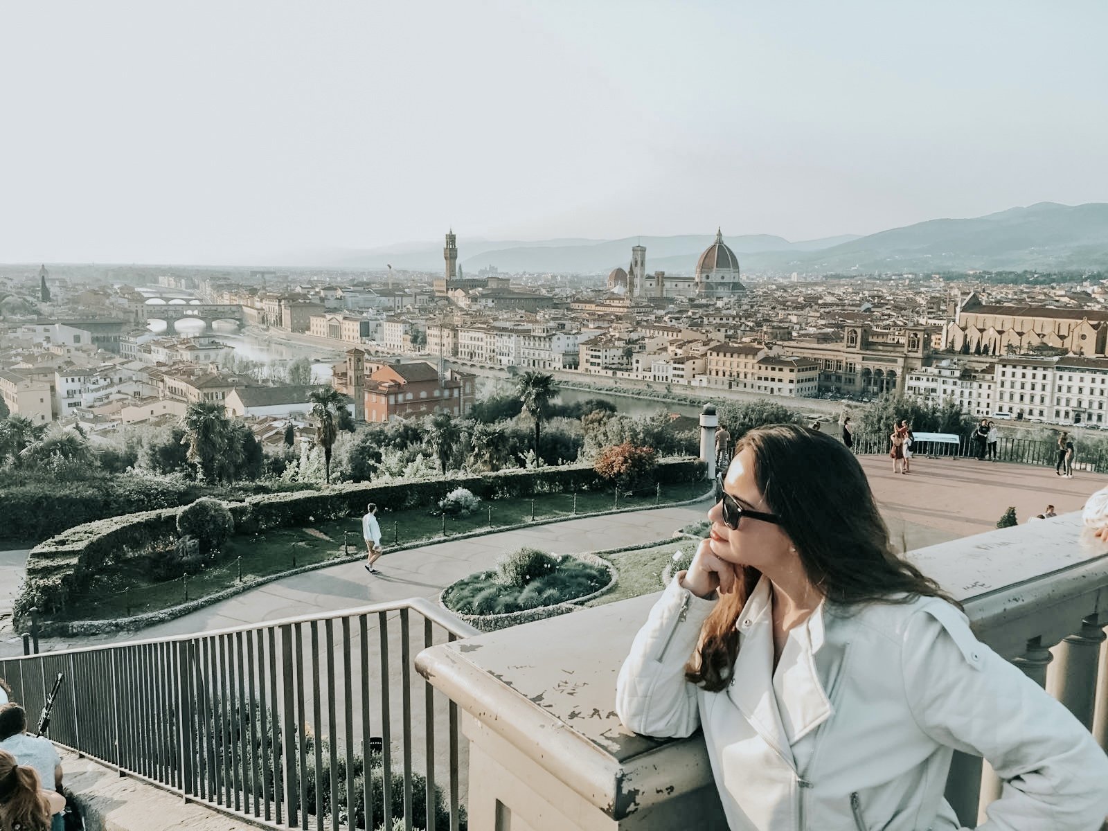 Woman leans her chin on her fist at the Piazza Michaelangelo in Italy