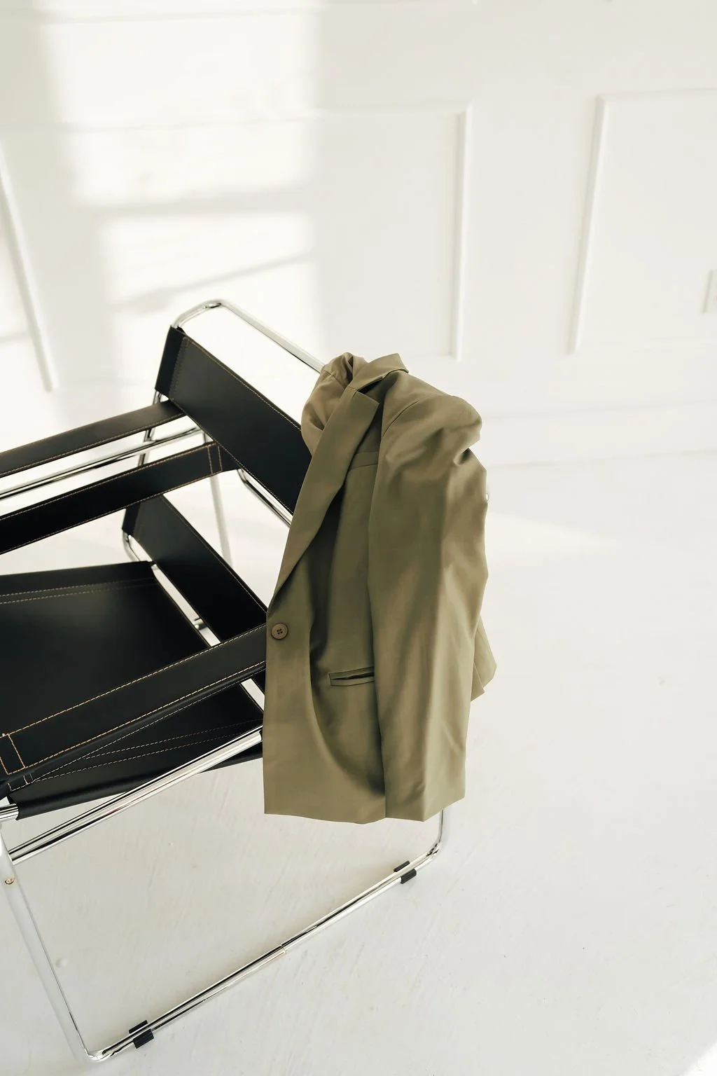 Black desk chair with a green suit jacket