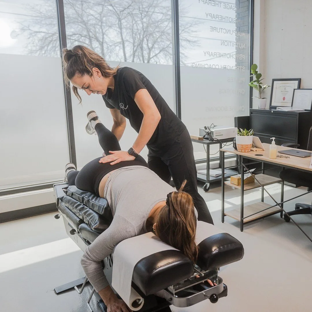 A chiropractor adjusting a woman's lower back in a clinic.