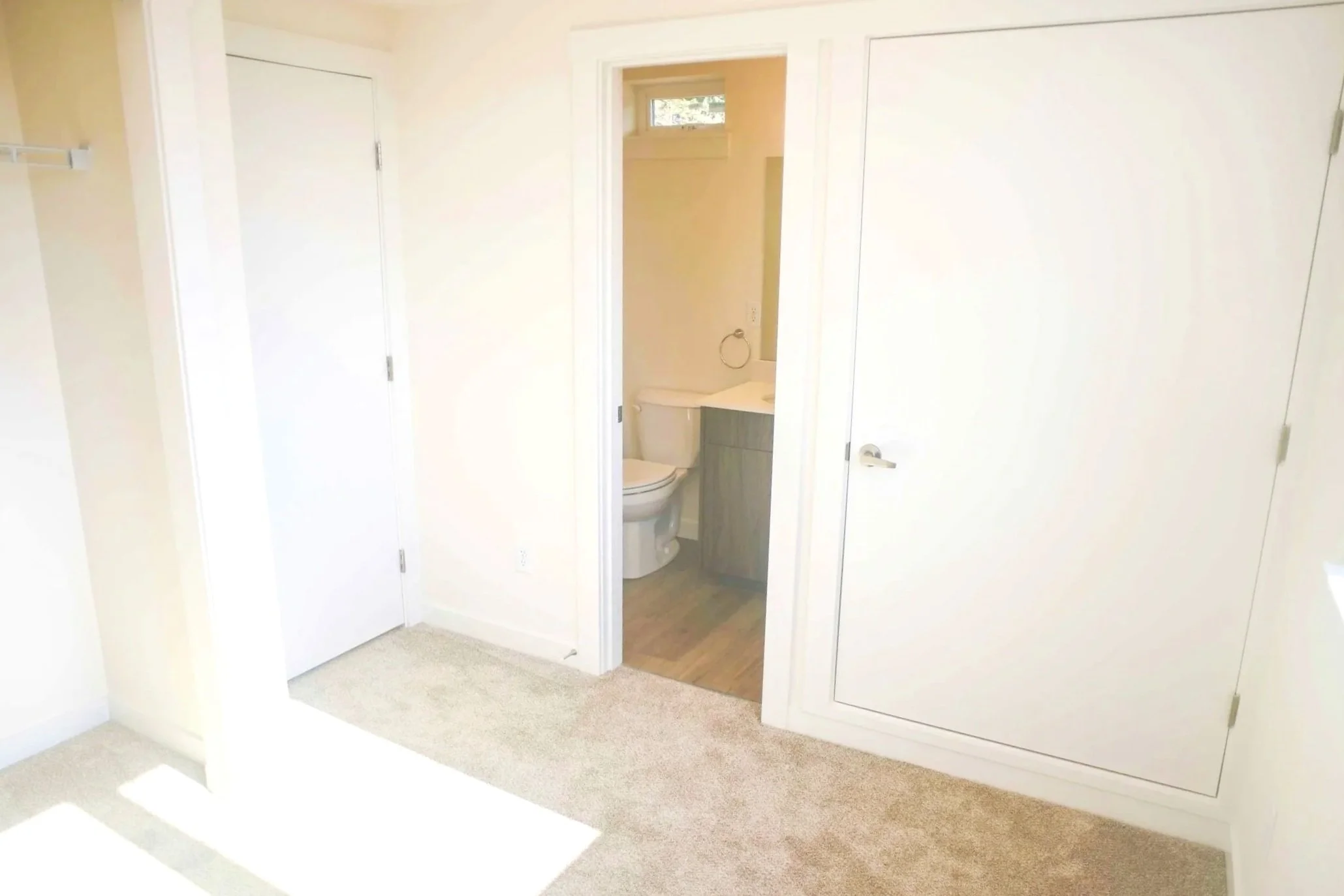 Interior view of Telegraph Townhomes 1D of bedroom with attached bathroom.