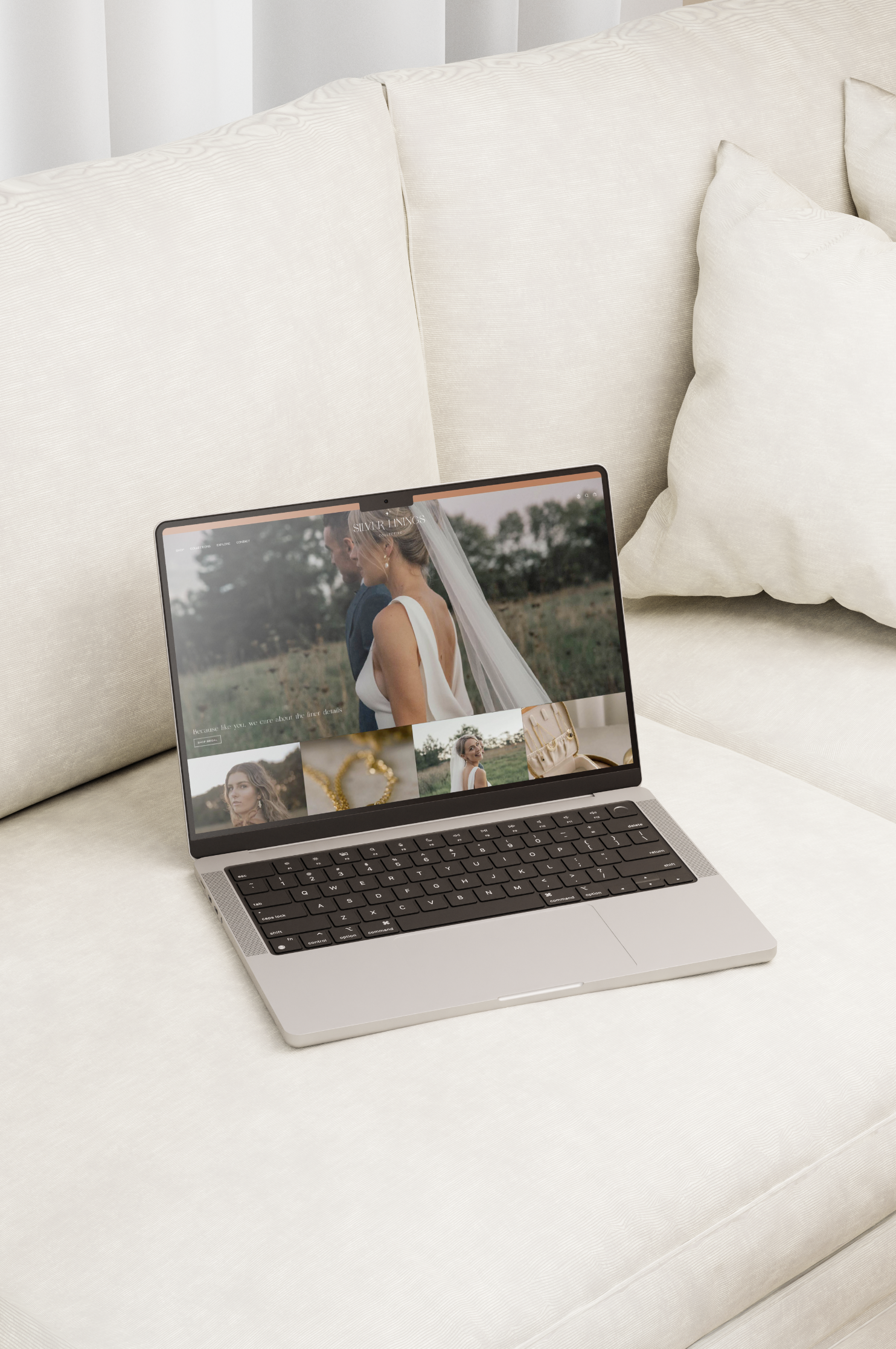 Open laptop on a beige couch displaying a wedding photography website homepage with bride images.