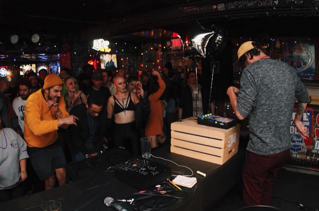 Korey Wade playing music to a crowd of fans.