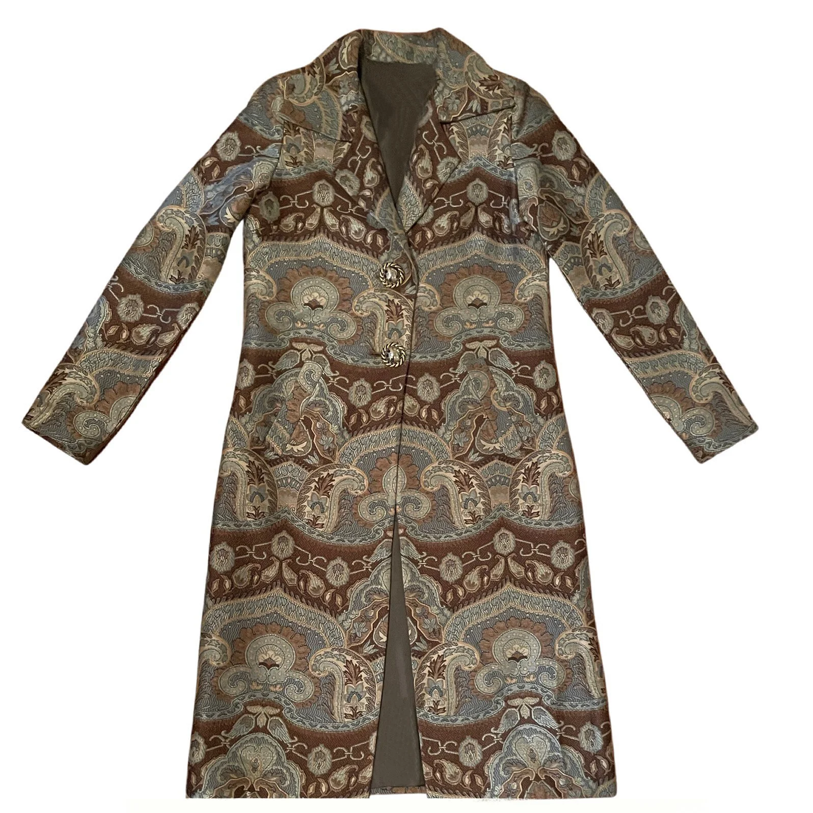 A tailored luxury statement coat in the Dusk colorway, showcasing a close-up of the muted blue-grey paisley weave artisanally crafted from Italian Lee Jofa Kamali fabric