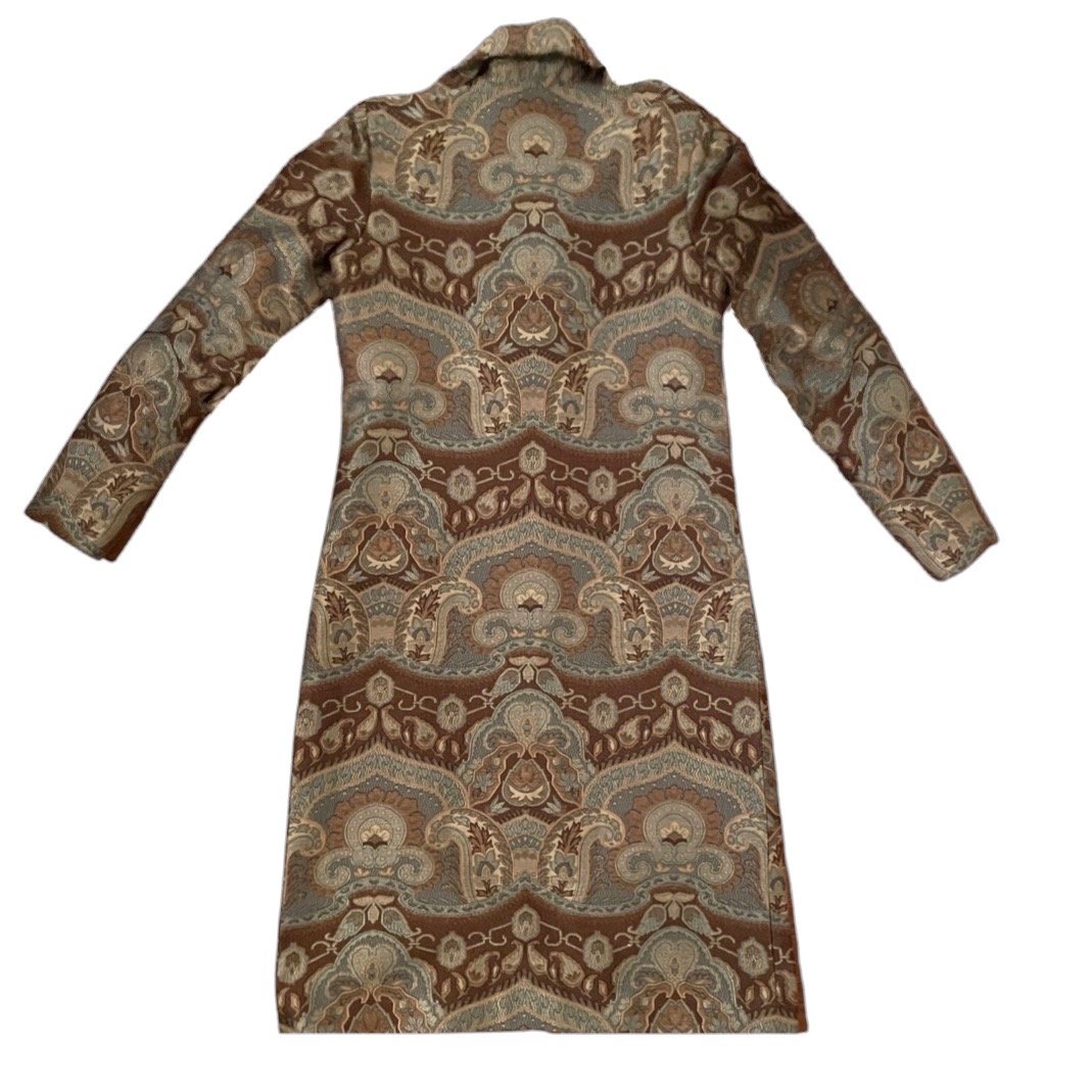 A tailored luxury statement coat in the Dusk colorway, showcasing a close-up of the muted blue-grey paisley weave artisanally crafted from Italian Lee Jofa Kamali fabric