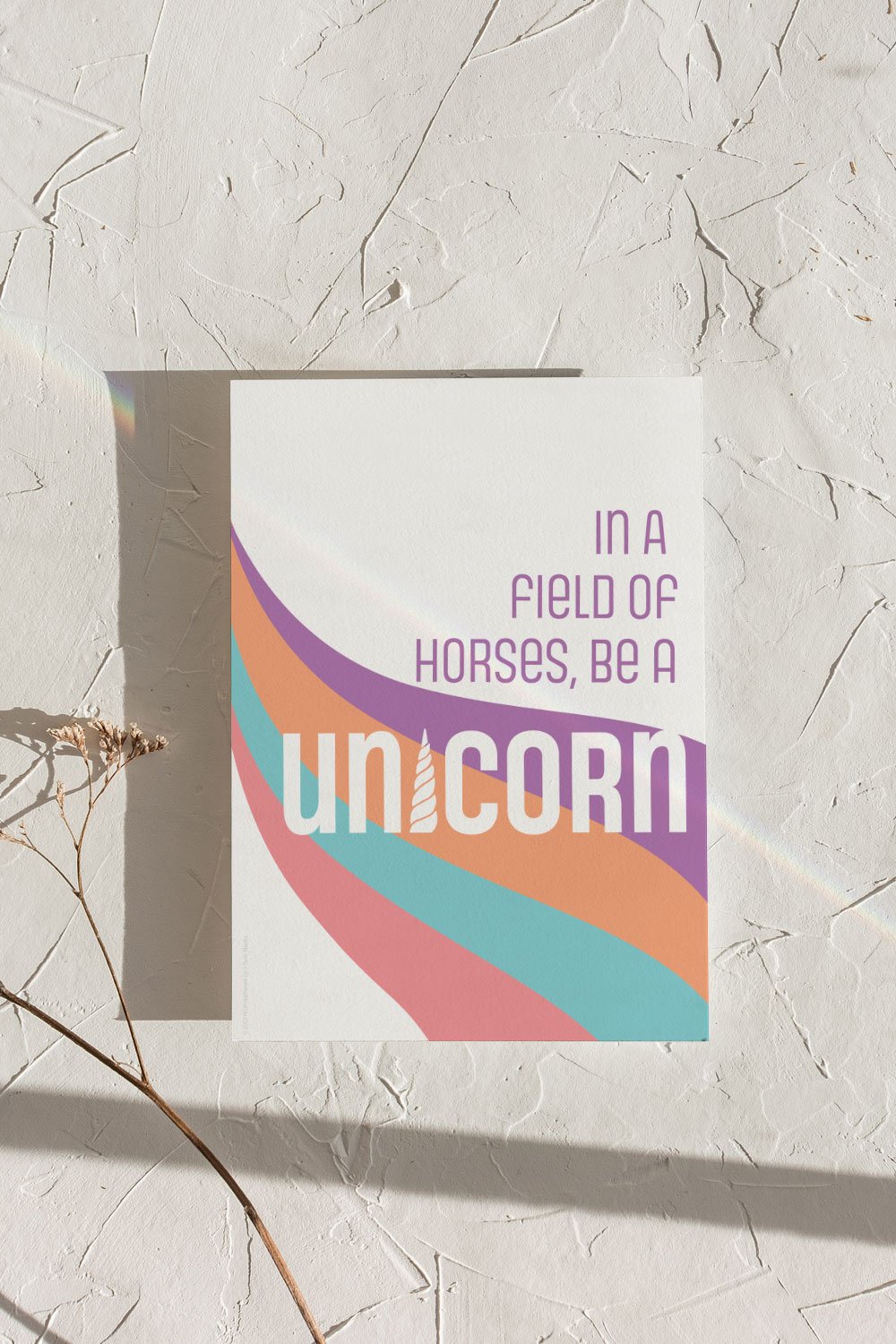 A clean and modern art print depicting the phrase “In a field of horses, be a unicorn”. Bold and bright color scheme, perfect for kids room or playroom.