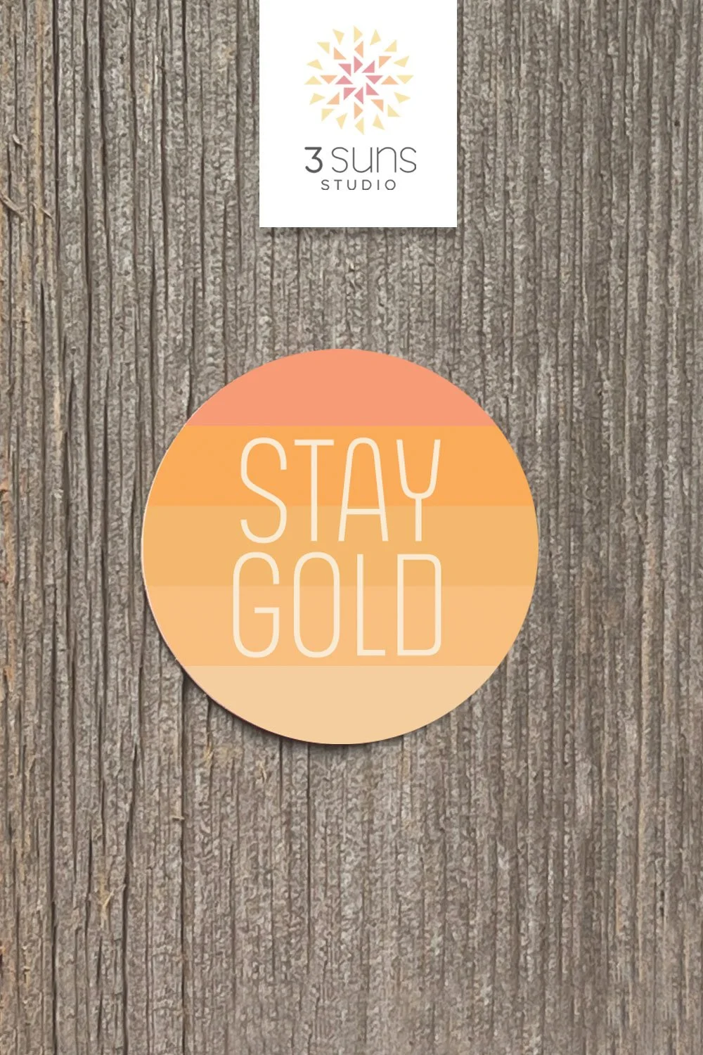 A clean and simply designed sticker depicting the inspirational phrase “Stay Gold”. Boho color scheme of orange and gold.