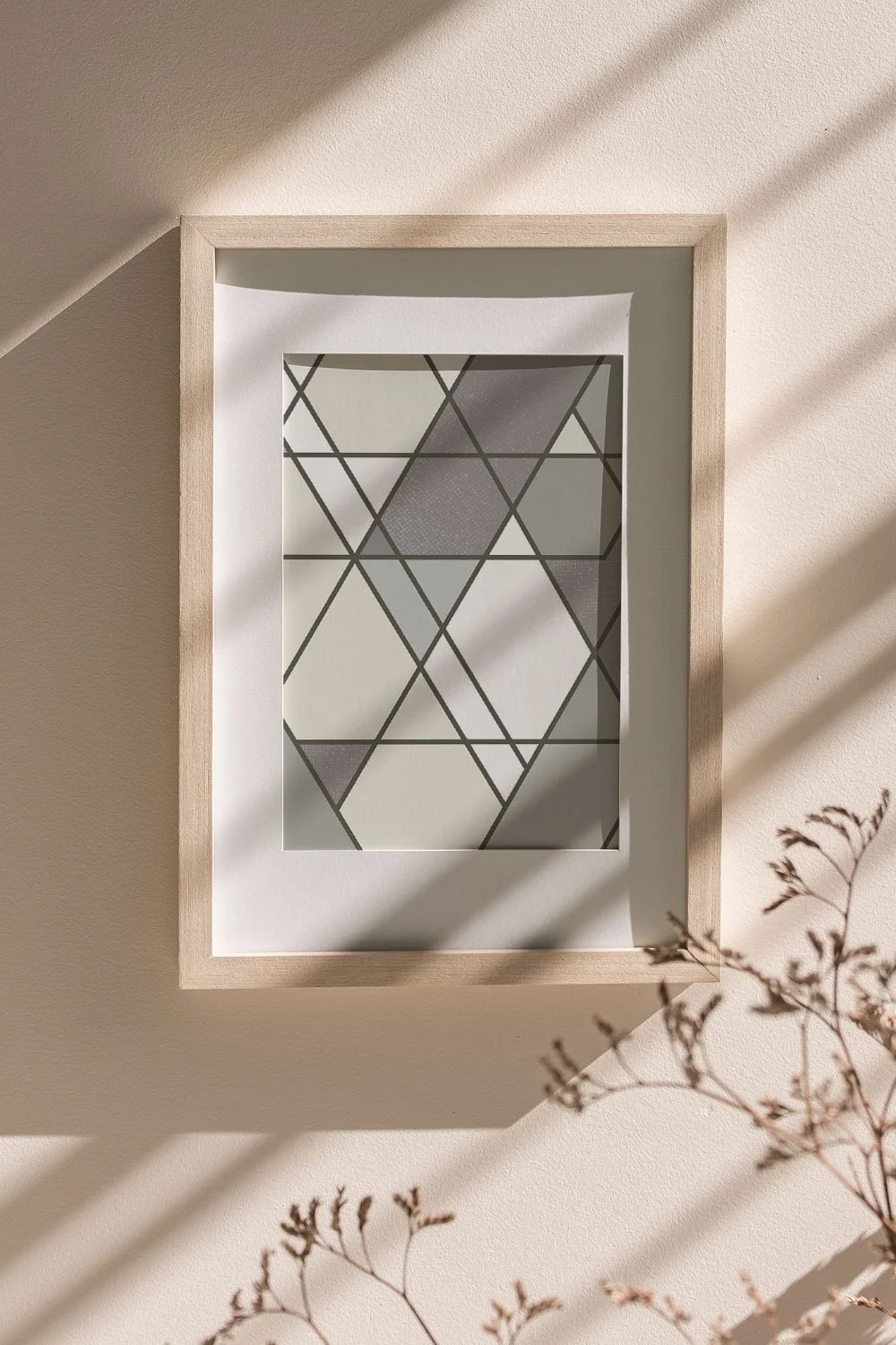 A modern geometric art print by 3 Suns Studio featuring intersecting triangles and diamonds in warm beiges, grays and cream.