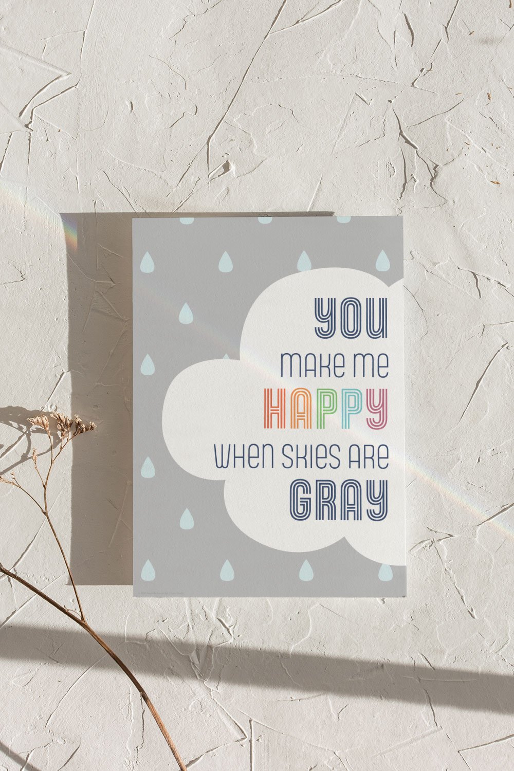 A clean and modern art print depicting the song lyric “you make me happy when skies are gray”. Bold and bright color scheme, perfect for kids room or playroom.
