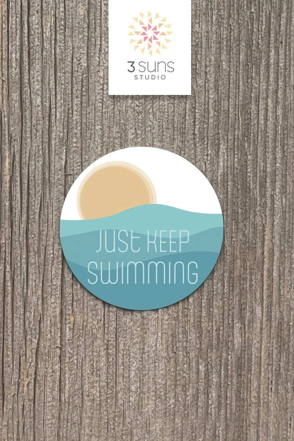 A clean and simply designed sticker depicting the inspirational phrase “Just keep swimming”. Boho color scheme of gold and blue green.
