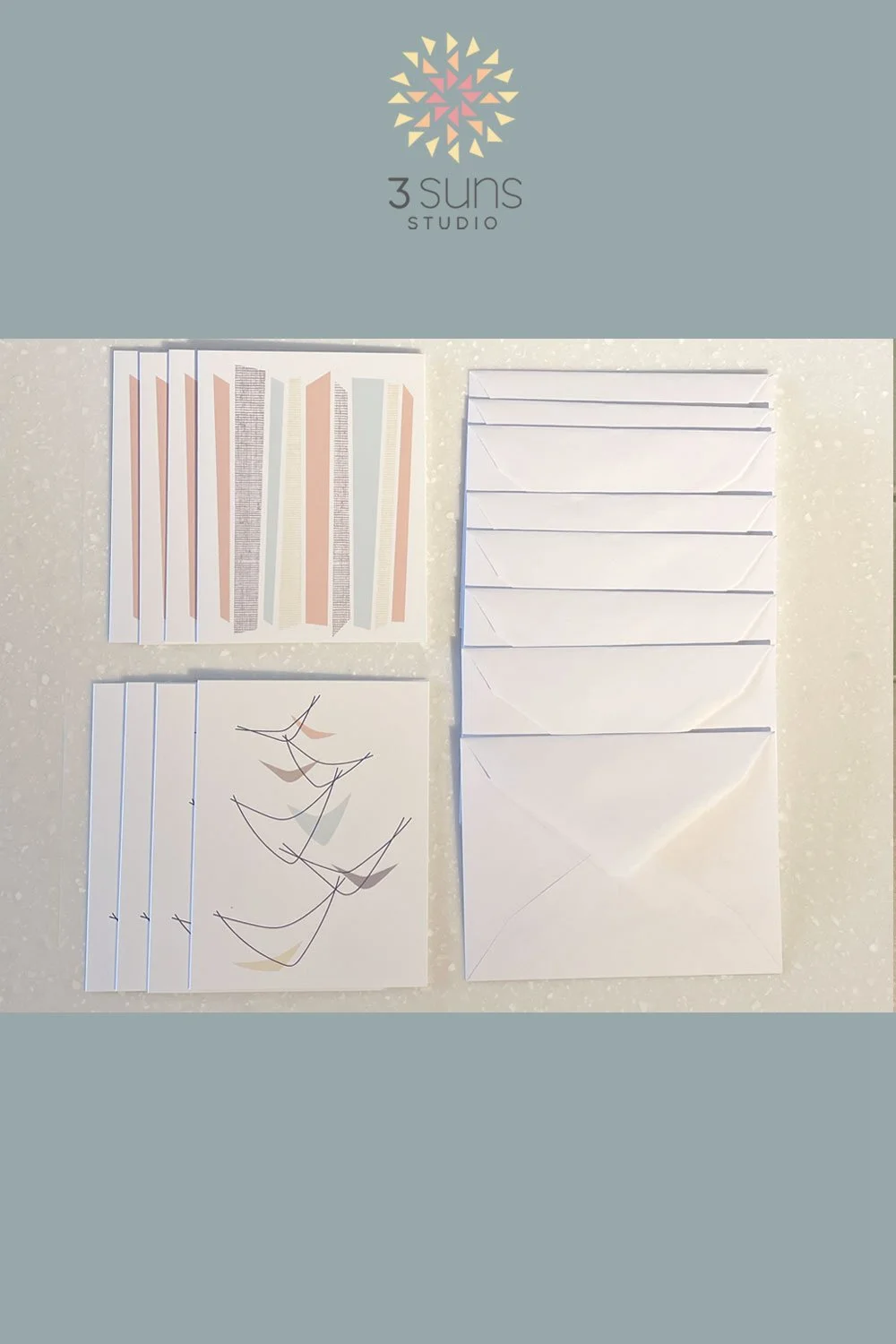 Set of 8 blank notecards, featuring 2 mid-century modern inspired designs. Includes 8 white envelopes.