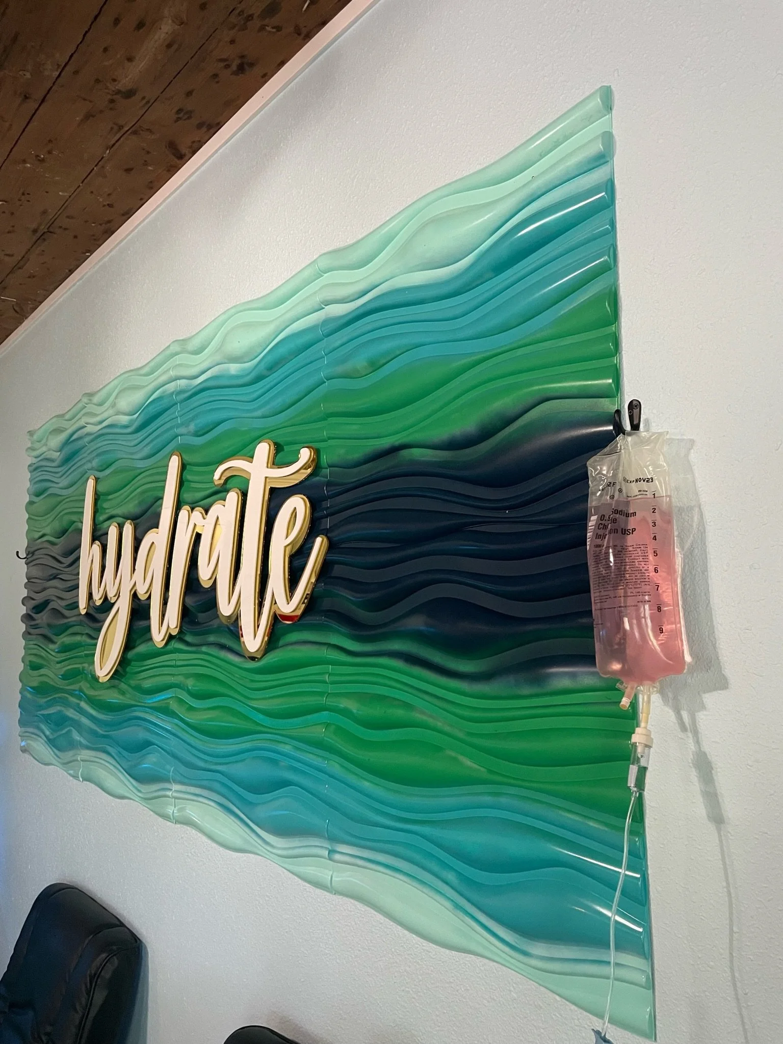Vitamin IV infusion with tailored beauty skin slow support hanging in front of the hydrate sign at The Irenic Place in Aledo, Texas