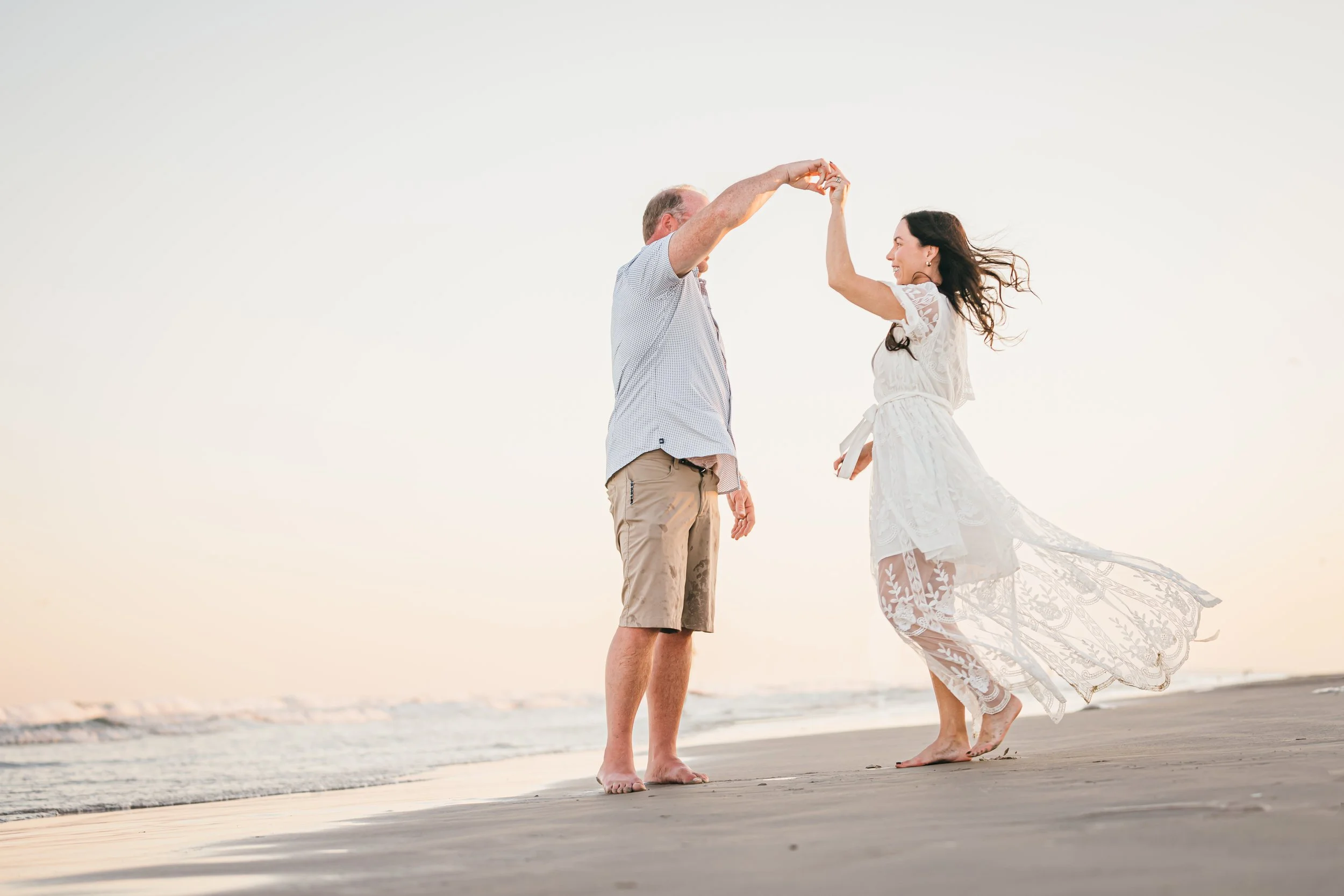Husband and wife dancing on the beach after learning health shouldn't be fragmented and opened The Irenic Place in Aledo, Texas