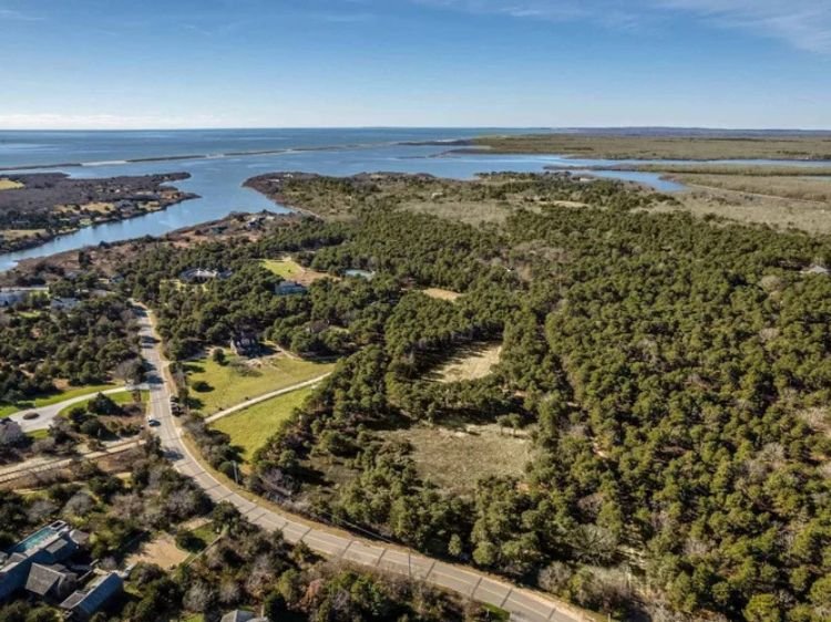 Aerial color image of Edgartown, Martha's Vineyard, Turkeyland Cove., with ocean in the distance.