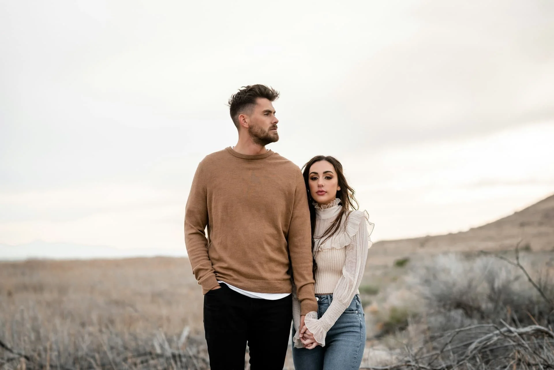 a-man-and-a-woman-standing-in-a-field