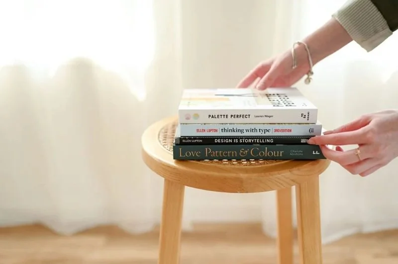 Stack of brand design books used for inspiration during a brand refresh and visual identity planning.