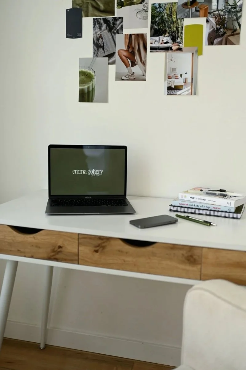 Minimal home office desk with laptop displaying Emma Gohery Designs, symbolizing clarity after fixing the biggest branding mistakes.