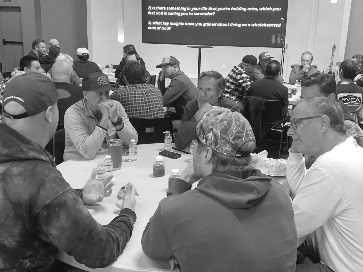 A few men gathered together eating food