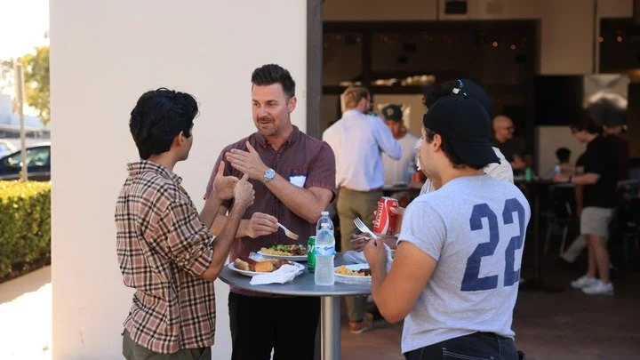 A few men gathered together eating food
