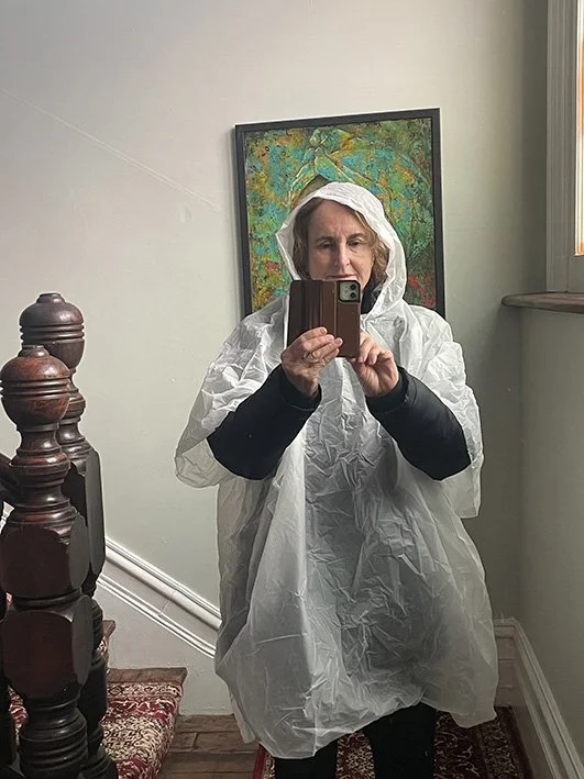 Stairwell mirror of me in my walking rainwear gear
