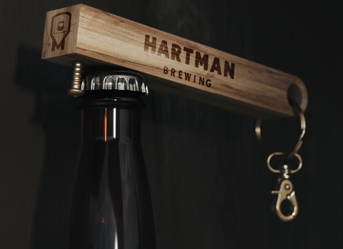 Close-up of beer bottle cap being opened with custom wooden Hartman Brewing bottle opener.