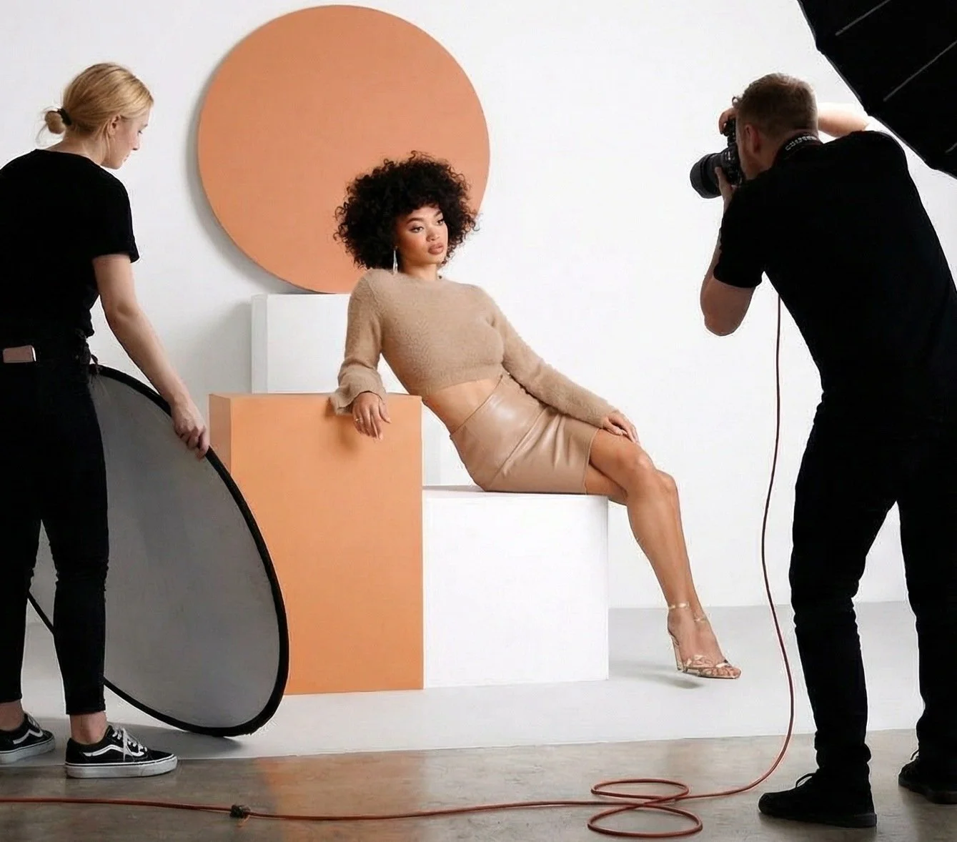 Behind-the-scenes photo shoot for Windsor Fashions Spring campaign featuring model on set with photographer and crew.