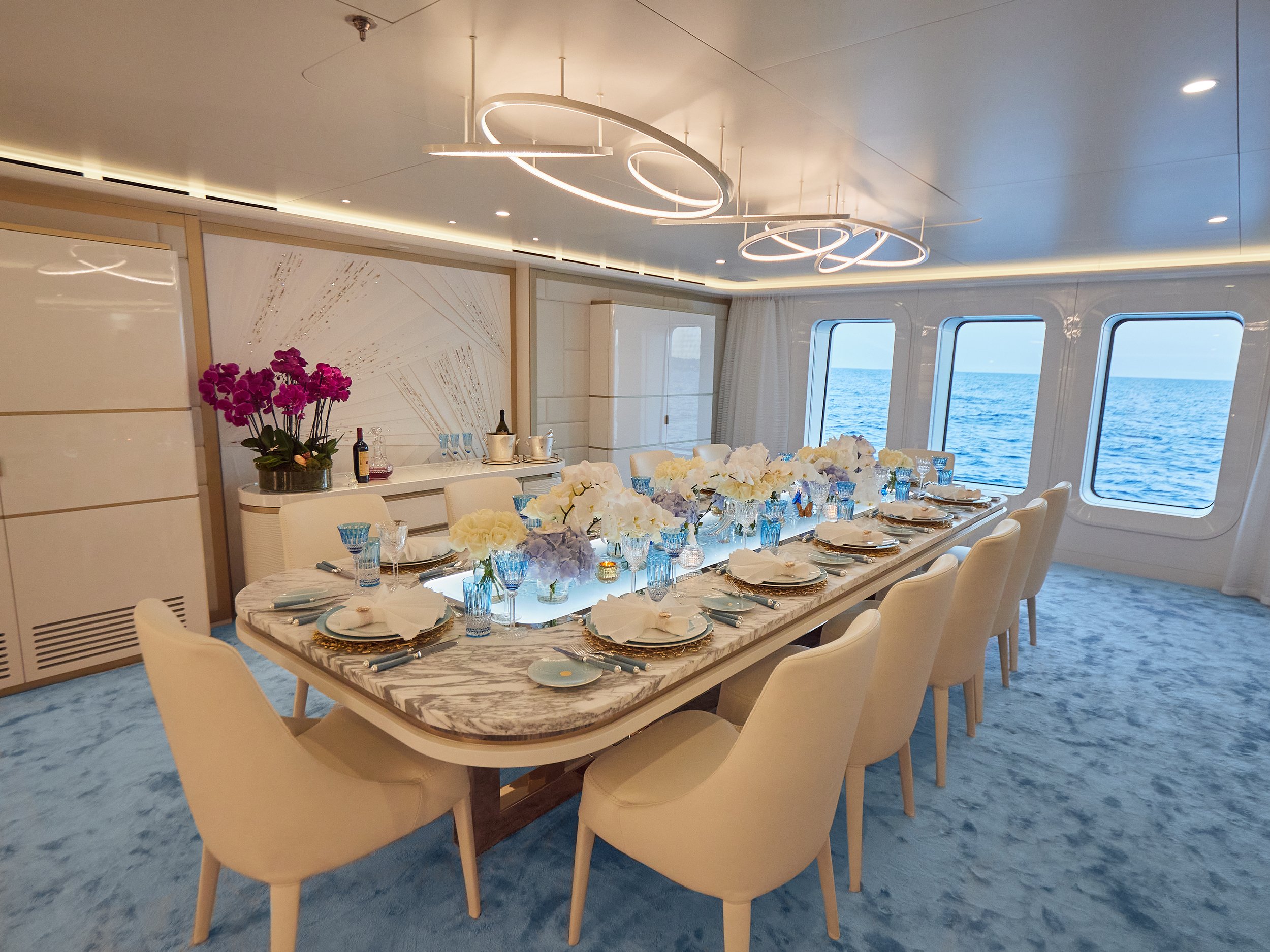 Dining Table, gold plated stainless steel, marble, cast glass.  OTAD / Blainey North
