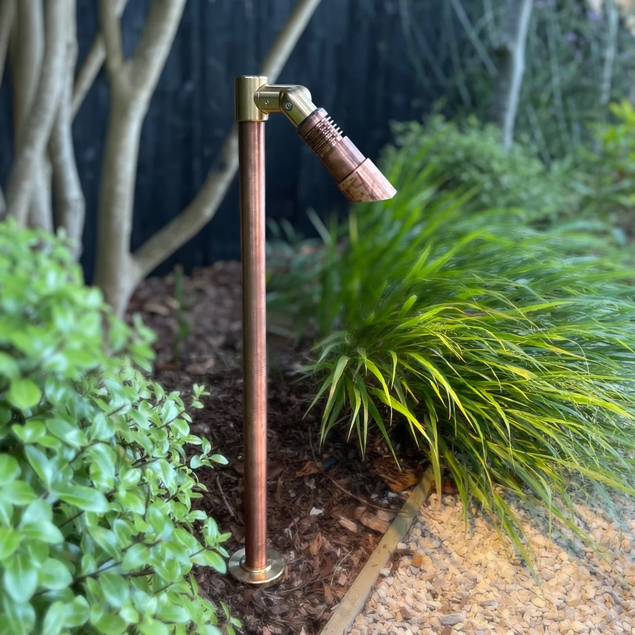 Light Visuals solid copper pole mount adjustable spot path down light in a mature garden
