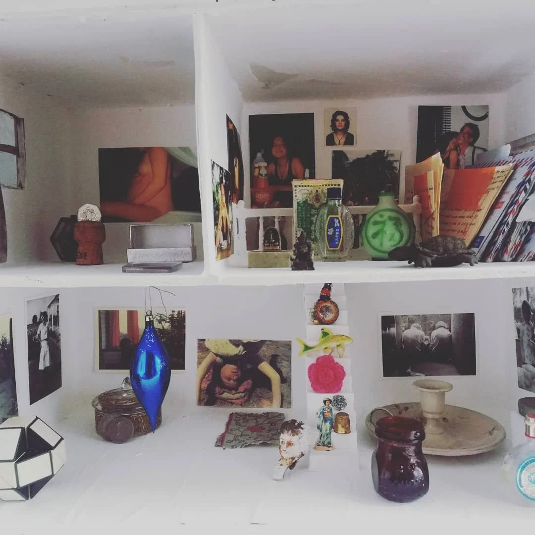 'Weaving Migrants' A year long research into the artists ancestors, from ancient royalty  to the Huguenot weavers. 
Image: Dollhouse White Cube. A miniature lockdown gallery space containing old family photos and treasured objects. 2020