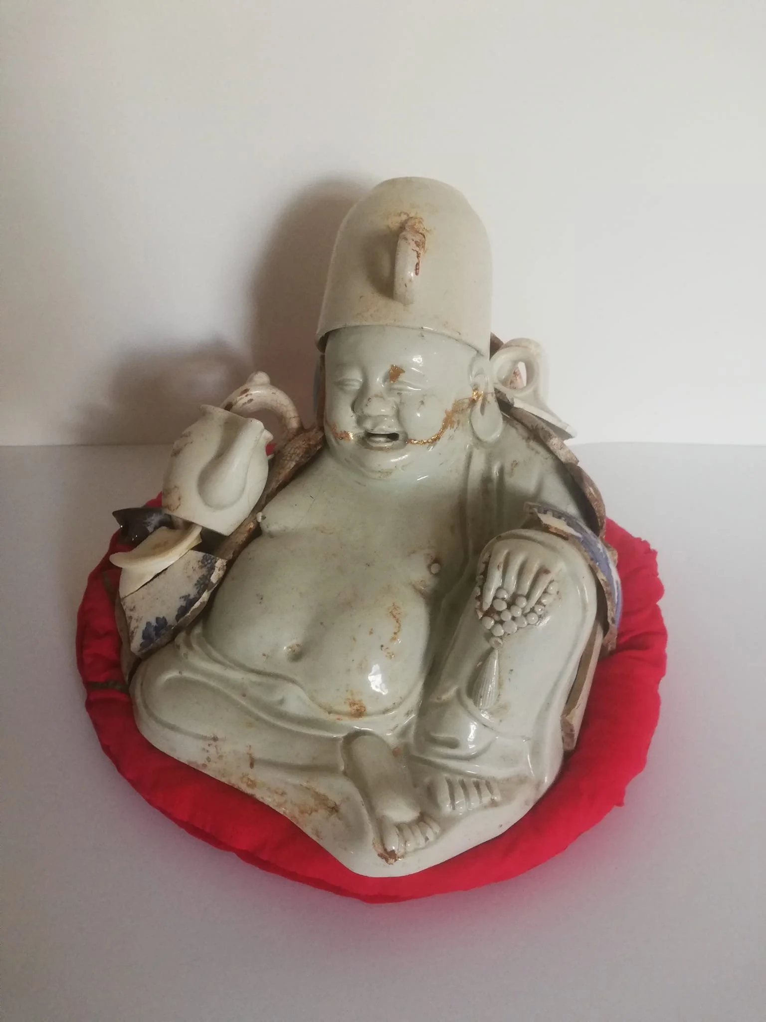 'Protective Spirits' Many countries have these spirits to protect against the dark. Clay, collage, marine plastic.
Image: The Buddha of Broken things. Found broken antiques ceramic pieces, cotton cushion, the protector of all who mend. 2021