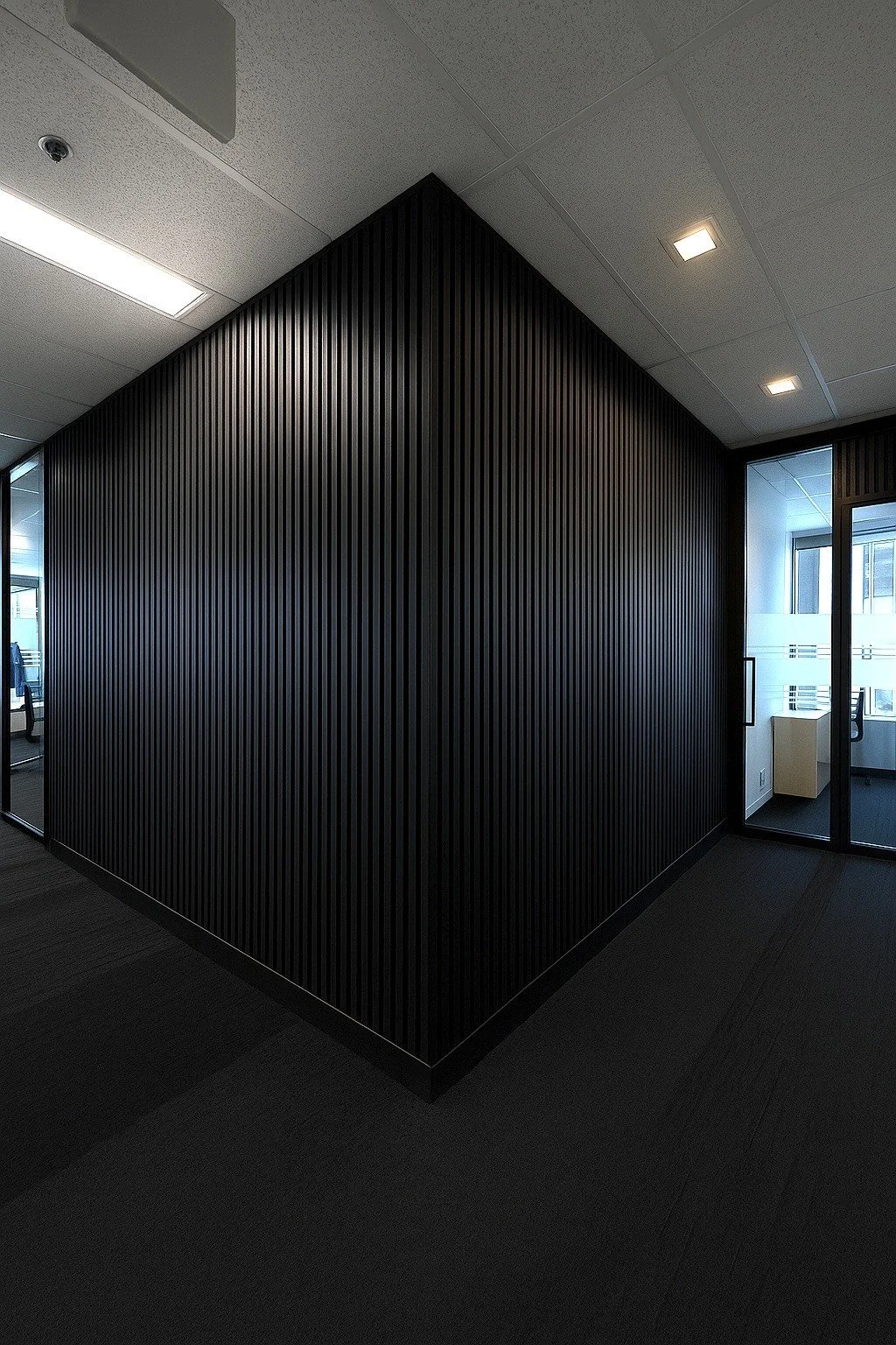 noisy office space treated with acoustic wood slats for sound proofing in office building in Calgary, AB