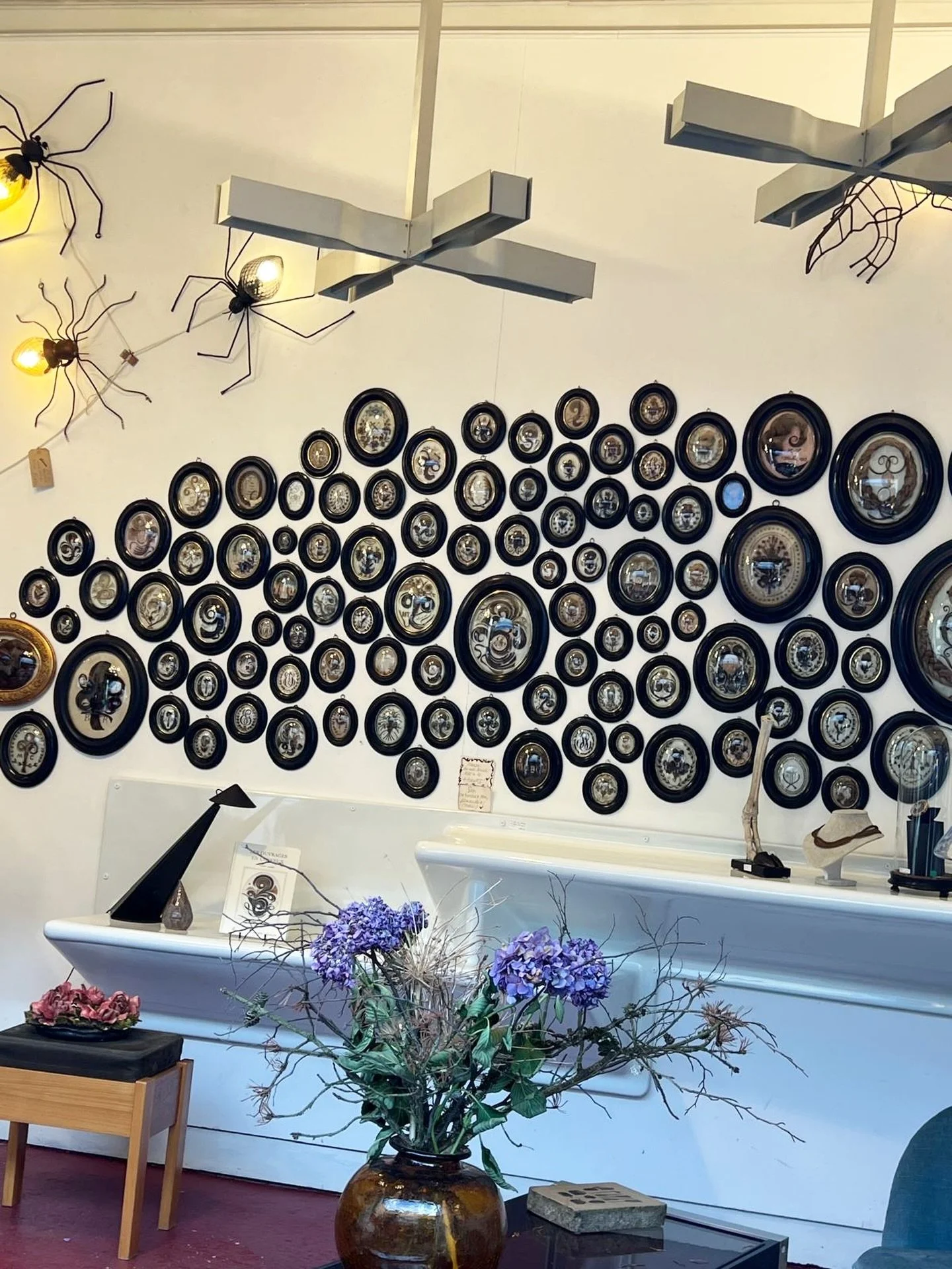 A wall like this stops you in your tracks ✨

Tucked inside a stall at the Puces in Paris, this collection of antique mirrors feels less like d&eacute;cor and more like a curated archive of time. Each piece&mdash;slightly foxed, softly aged, perfectly