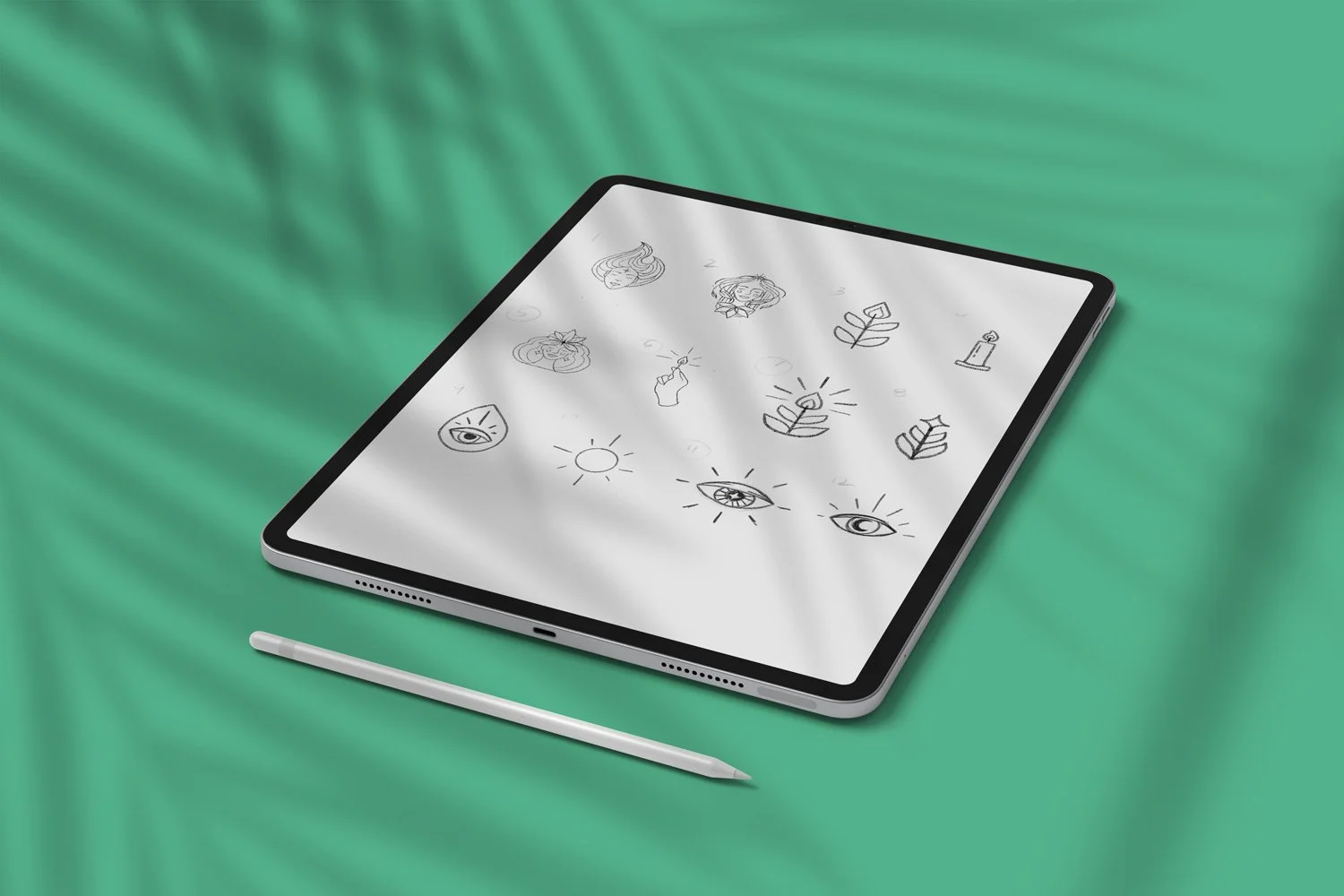 Tablet displaying hand-drawn icon sketches next to a stylus on a green surface.