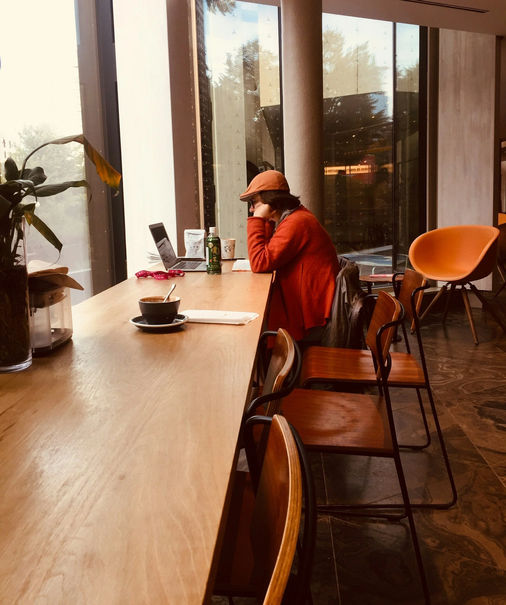 Young woman working at coffee shop alone