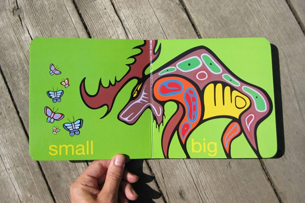 Play book spread with small butterflies and a large moose