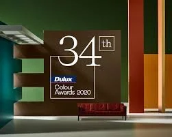 Poster for the 34th Dulux Colour Awards 2020, featuring abstract color blocks and a red sofa.