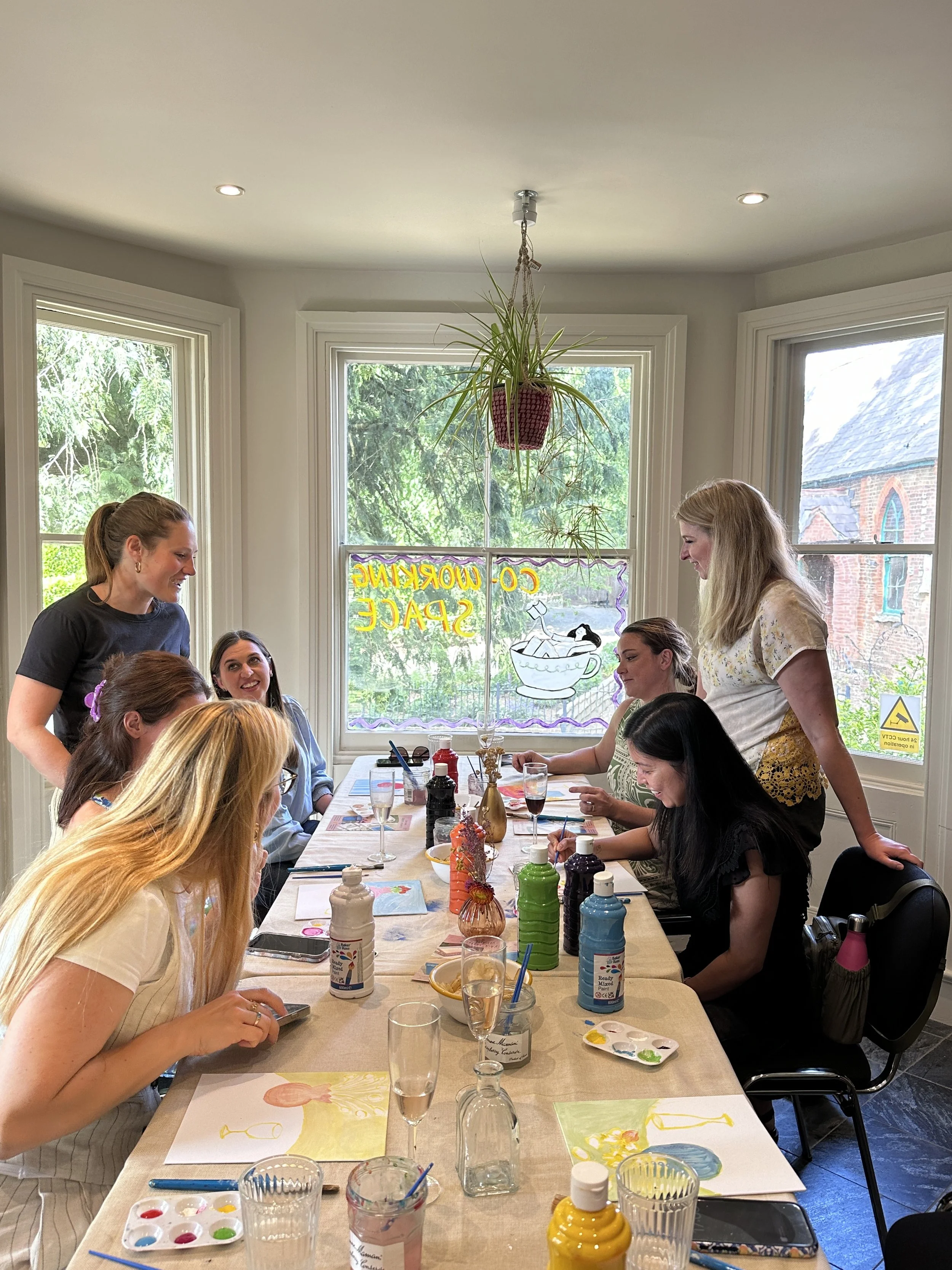 Group enjoying a coffee painting workshop at Amble in Gomshall, Surrey