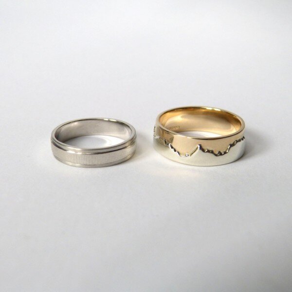 A platinum wedding ring and a 9ct yellow and white gold landscape ring