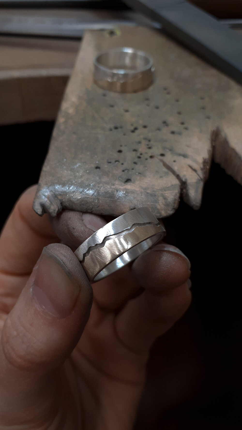 a-silver-and-gold-wedding-ring-part-way-through-polishing.jpg